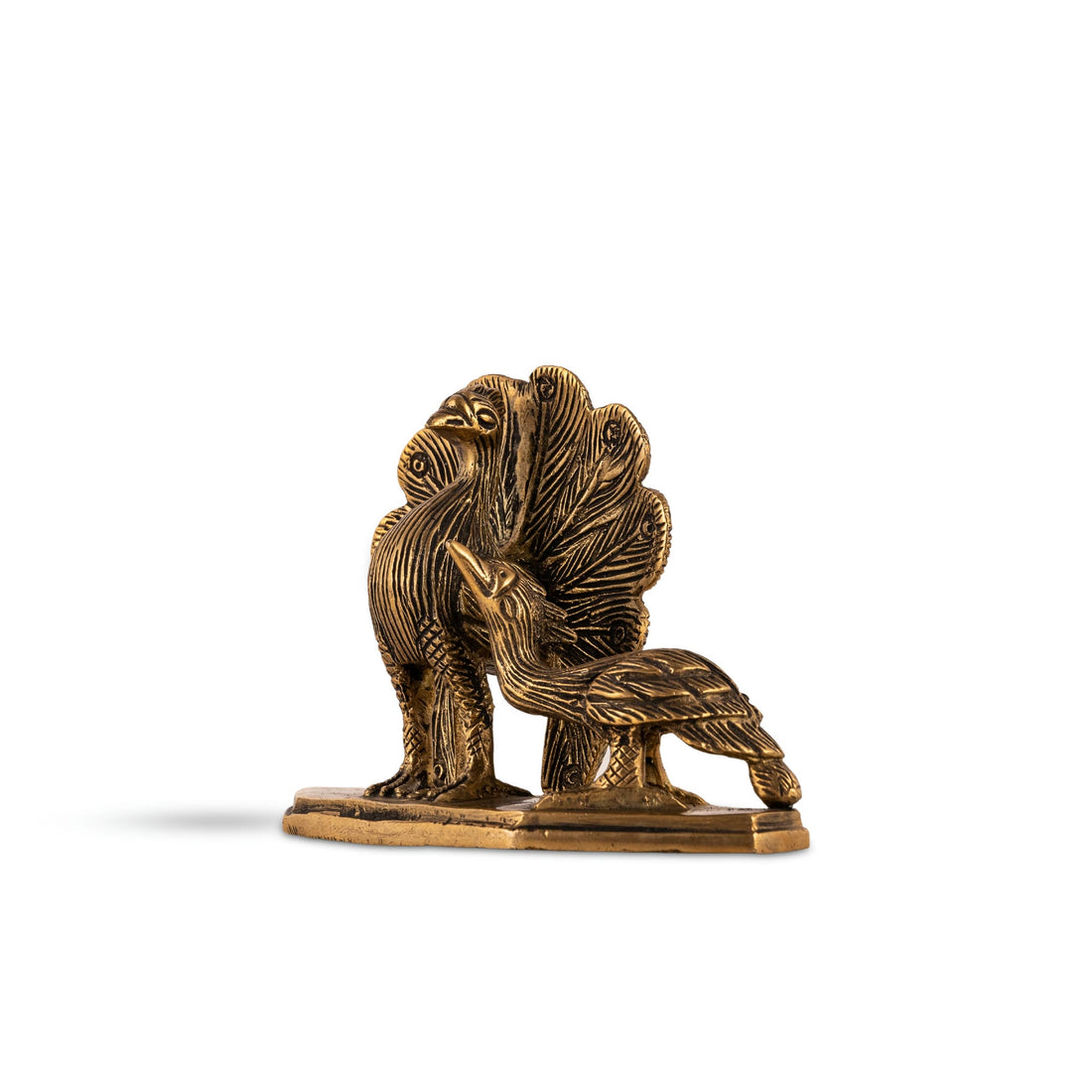 Brass Peacock Pair Sculpture in a royal courtship display on a curated bookshelf. 