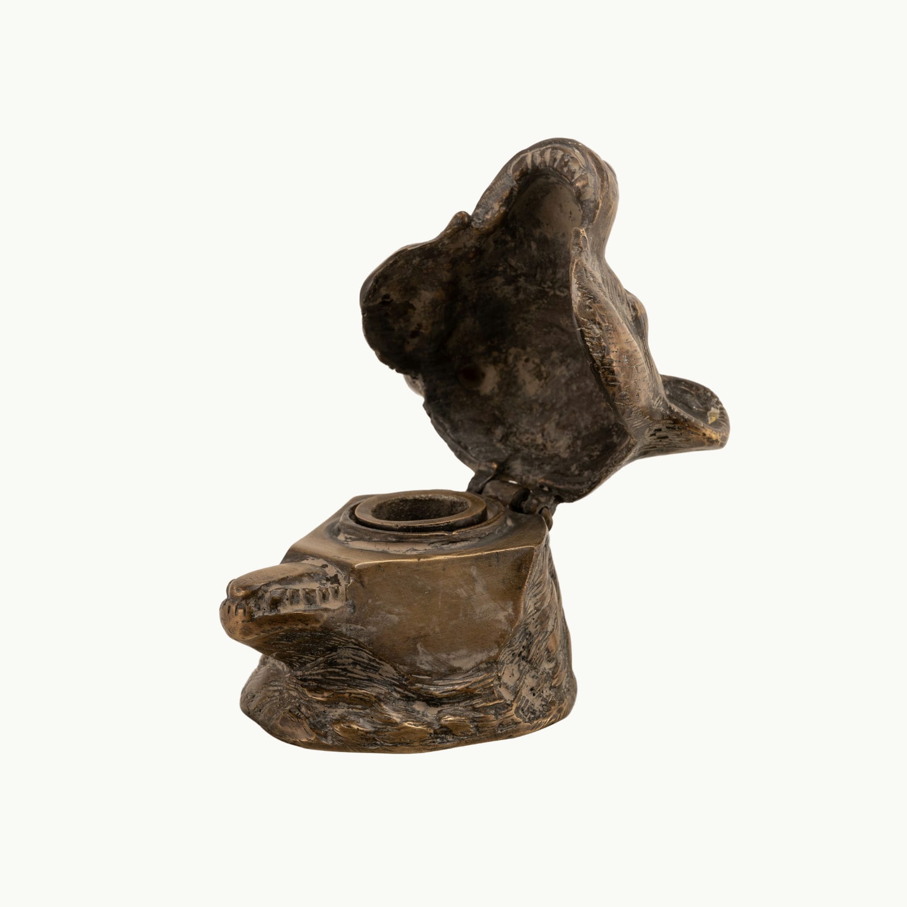 Antiqued Brass Bear Inkwell functioning as a rugged desk accessory on a study desk. 