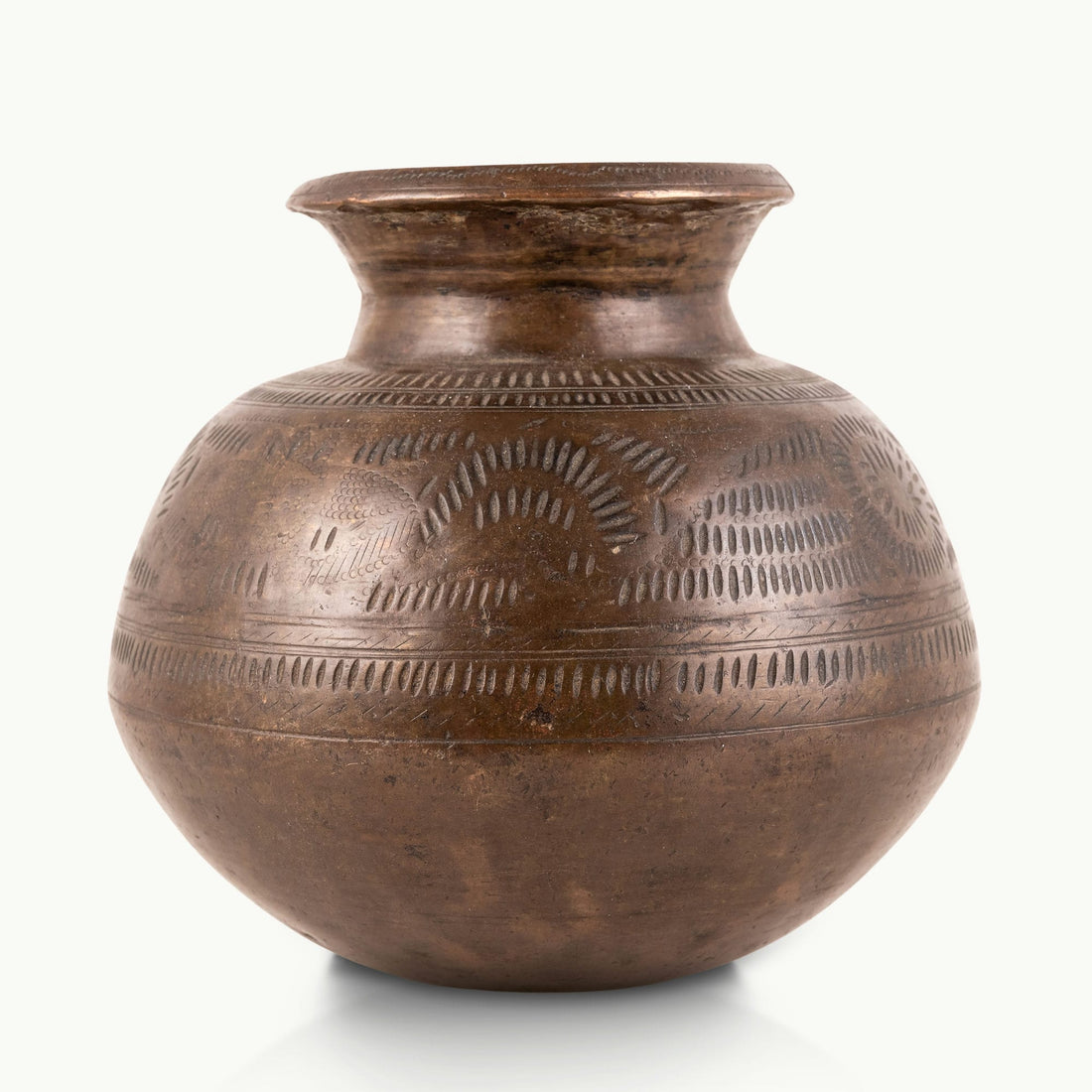 Stamped Antique Brass Water Pot covered in rhythmic dashes for a raw concrete console.