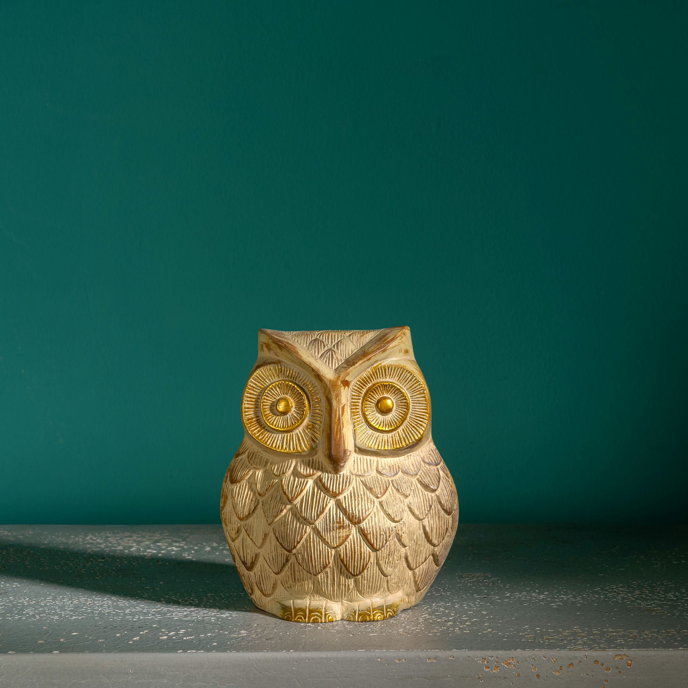Whitewashed textured owl figurine with gilded eyes and accents