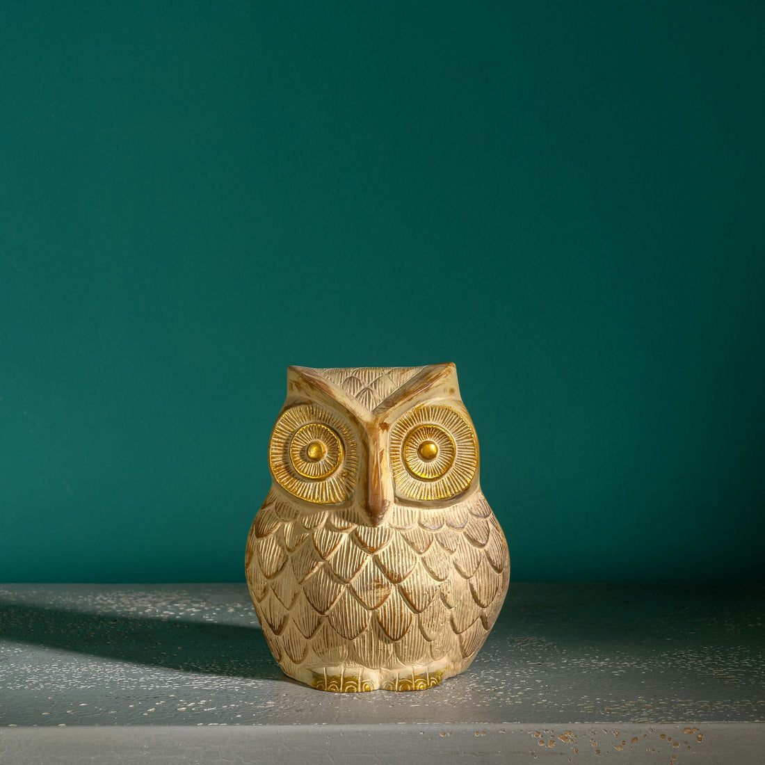 Whitewashed textured owl figurine with gilded eyes and accents