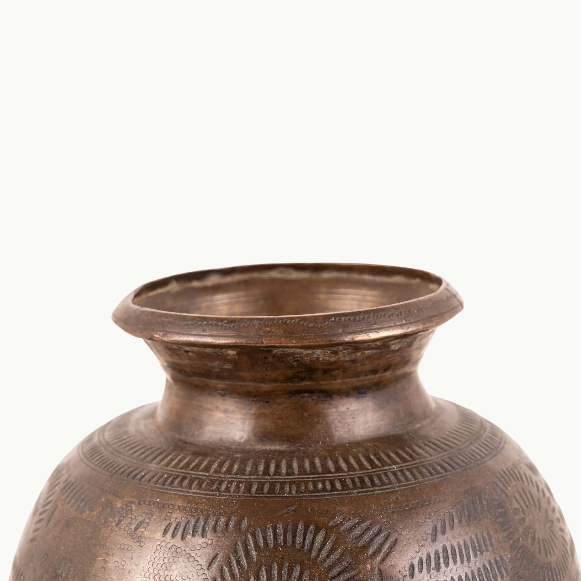 Stamped Antique Brass Water Pot covered in rhythmic dashes for a raw concrete console.