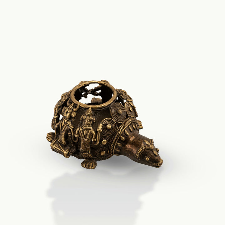 Dhokra Brass Tortoise Tealight Holder casting shadows on a sheltered patio bench. 