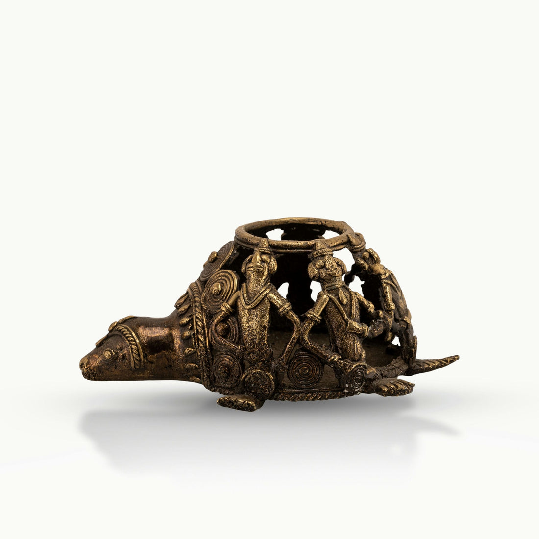 Dhokra Brass Tortoise Tealight Holder casting shadows on a sheltered patio bench. 