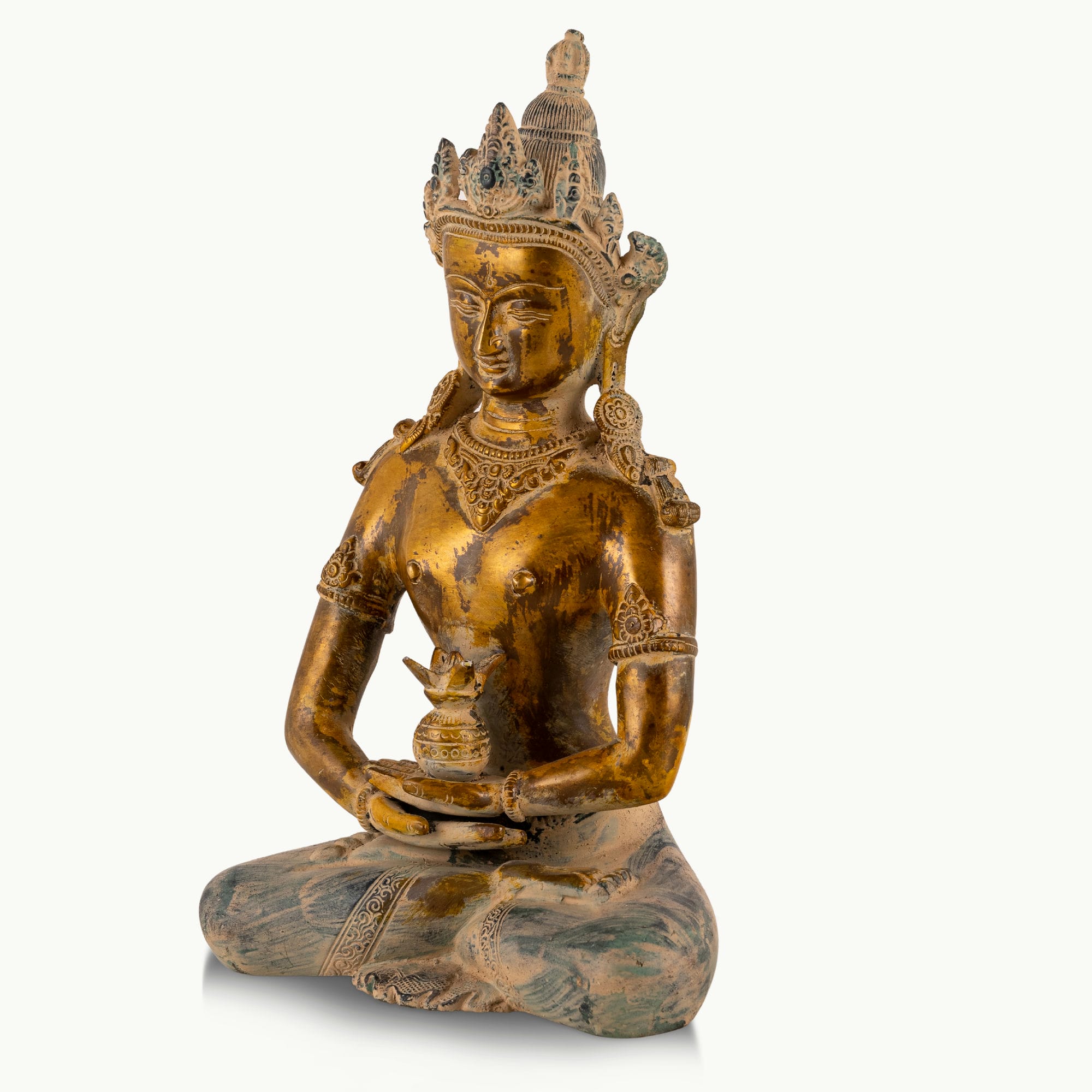 Distressed Brass Tara Statue holding the Amrita Kalasha on a home altar. 