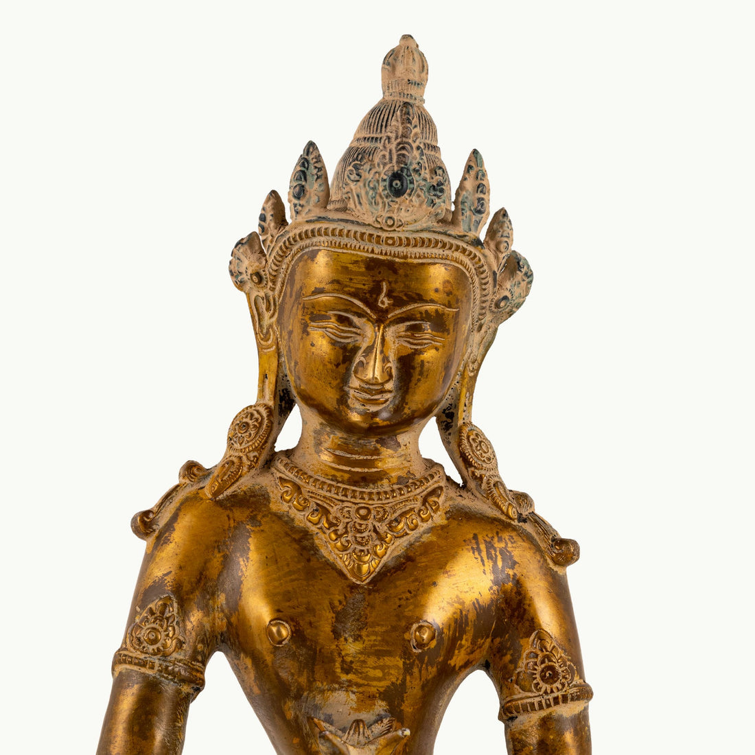 Distressed Brass Tara Statue holding the Amrita Kalasha on a home altar. 