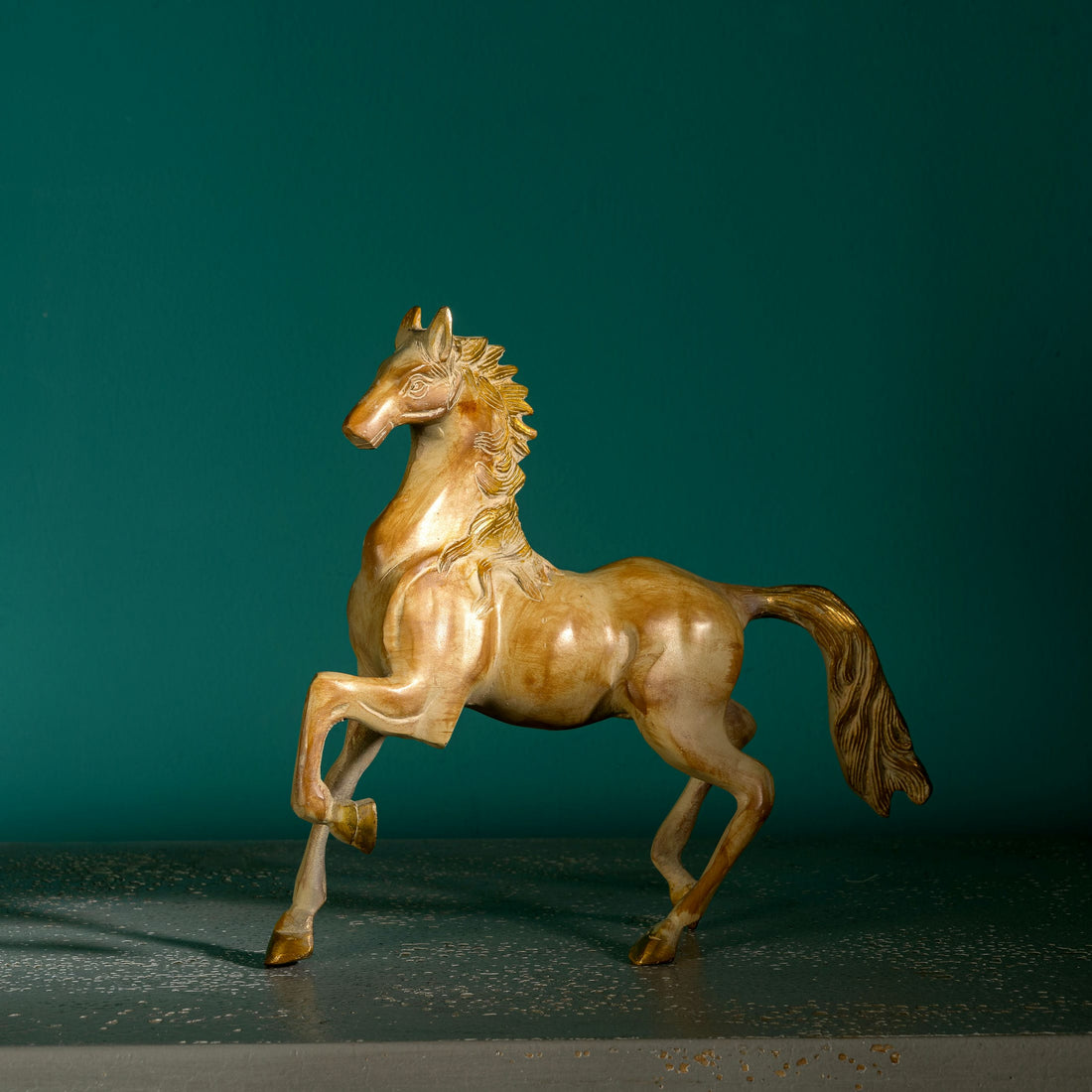 Antique resin-cast stylized horse figurine with gilded mane and tail