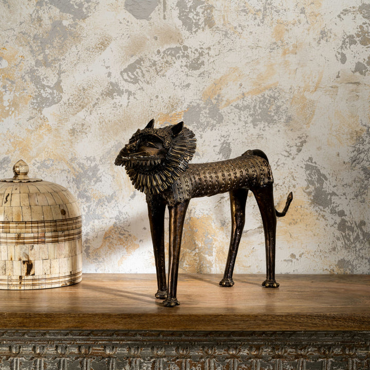 Dhokra style bronze feline featuring a wire-like mane and tribal geometry for a wide mantelpiece or rustic home styling.