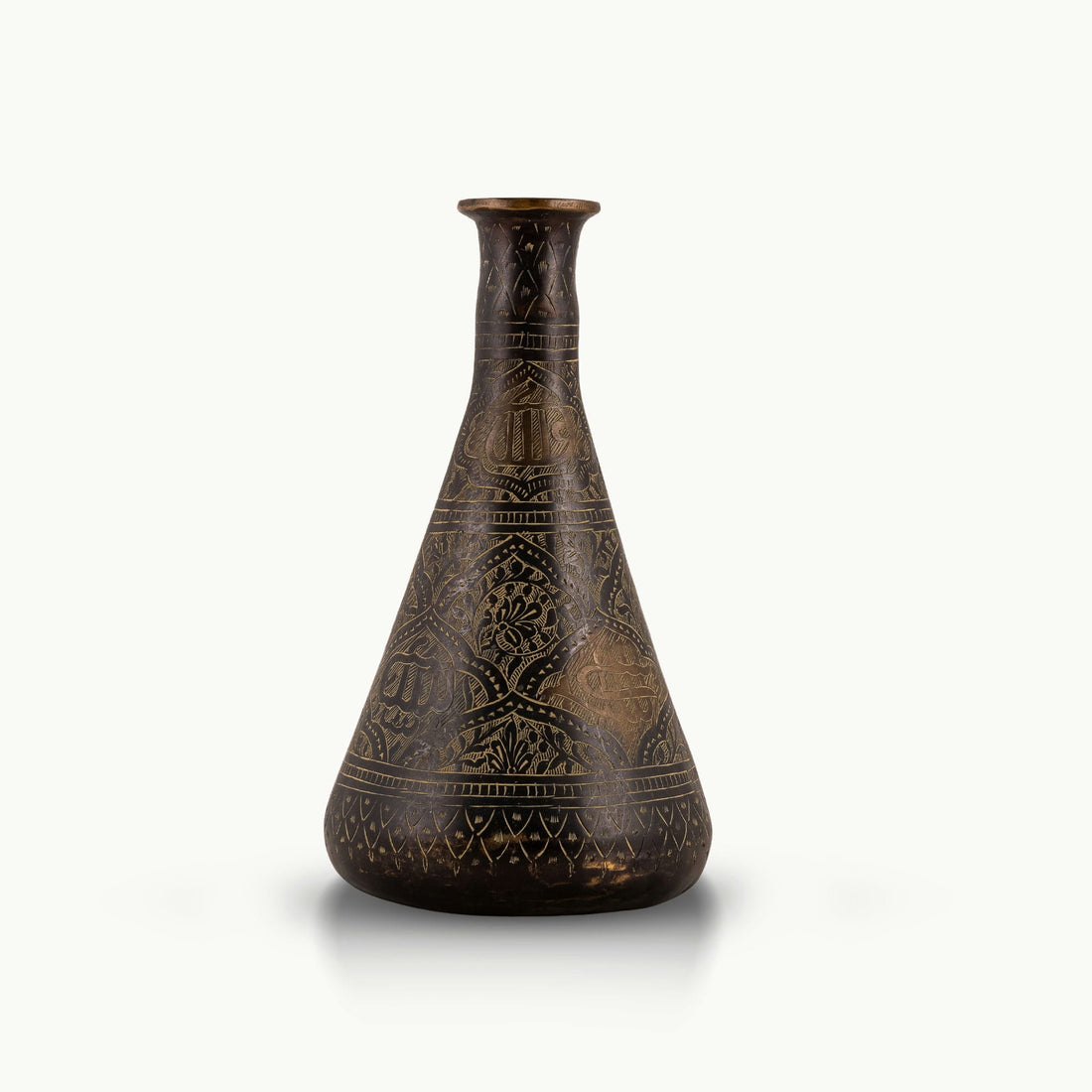 Engraved Brass Decorative Vase showcasing intricate stonework motifs on a neutral room console. 