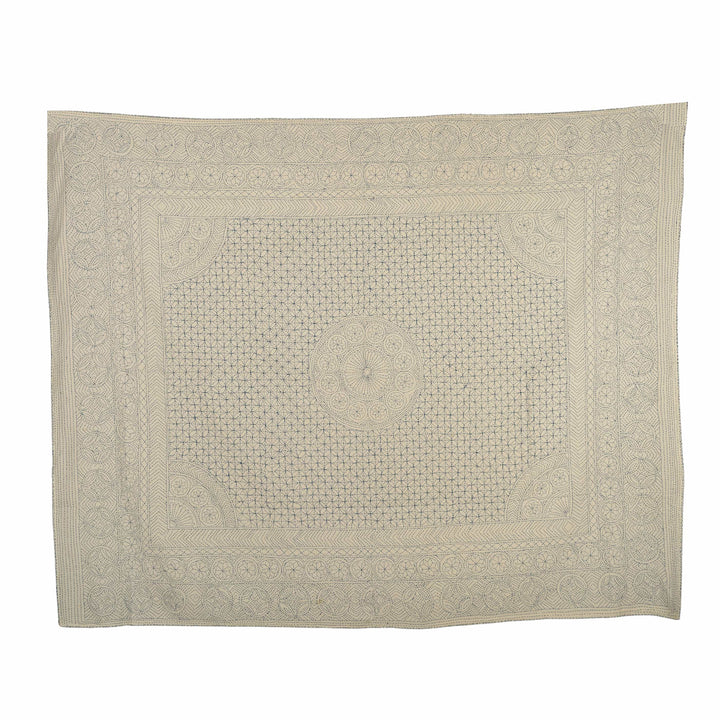 Indigo mandala kantha bedcover featuring hand-stitched interlocking circles and scalloped borders on a natural cream canvas.