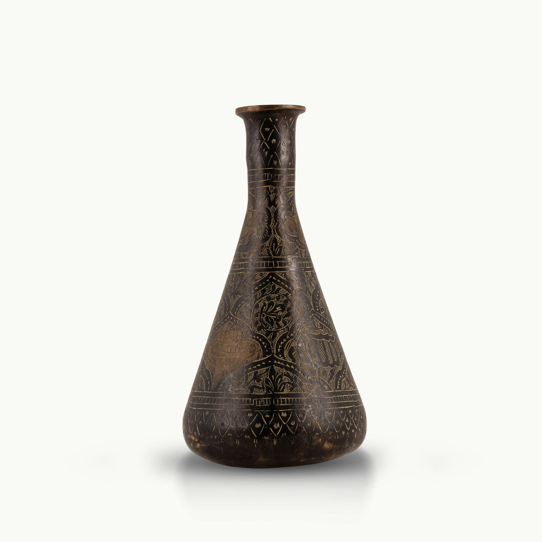 Engraved Brass Decorative Vase showcasing intricate stonework motifs on a neutral room console. 
