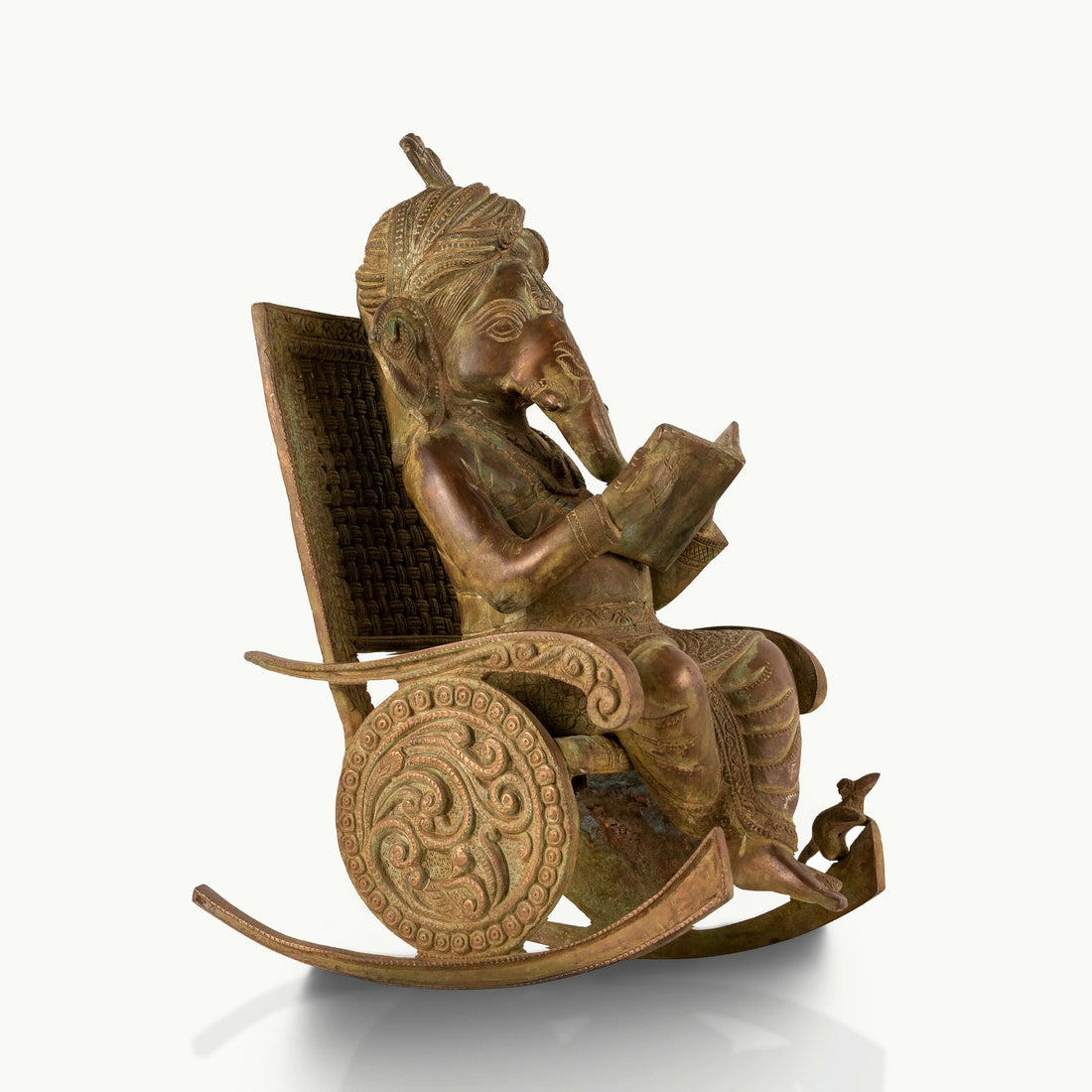 Antique Brass Rocking Chair Ganesha engrossed in a manuscript for a mahogany desk.