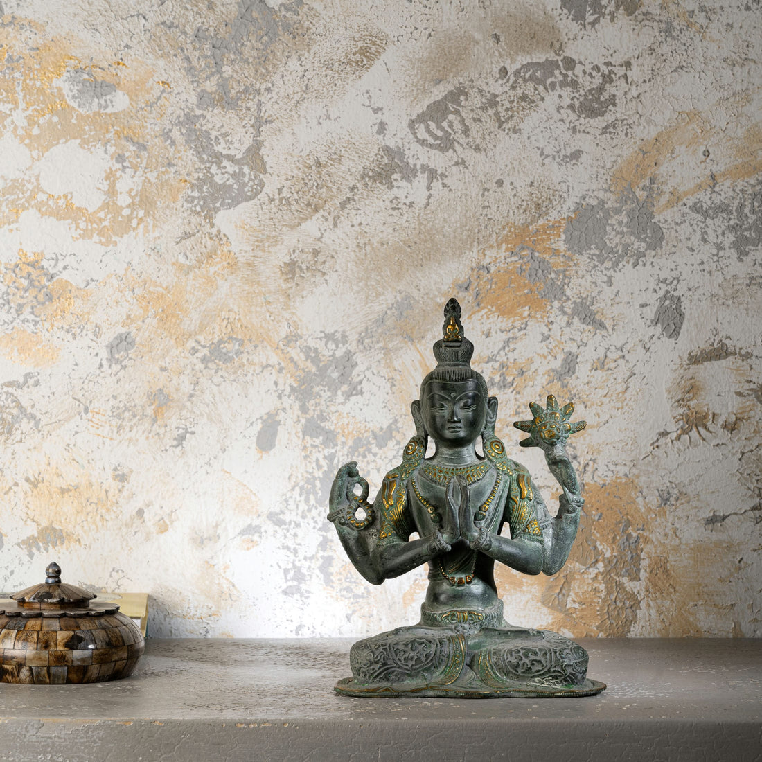Handcrafted verdigris metal Bodhisattva decor sitting in padmasana for a private study or zen space.