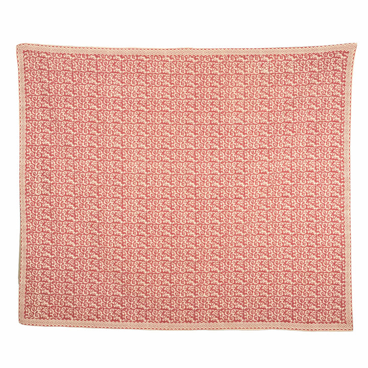Crimson damask kantha bedcover featuring a red botanical vine grid on a natural cream base, styled in a master suite.
