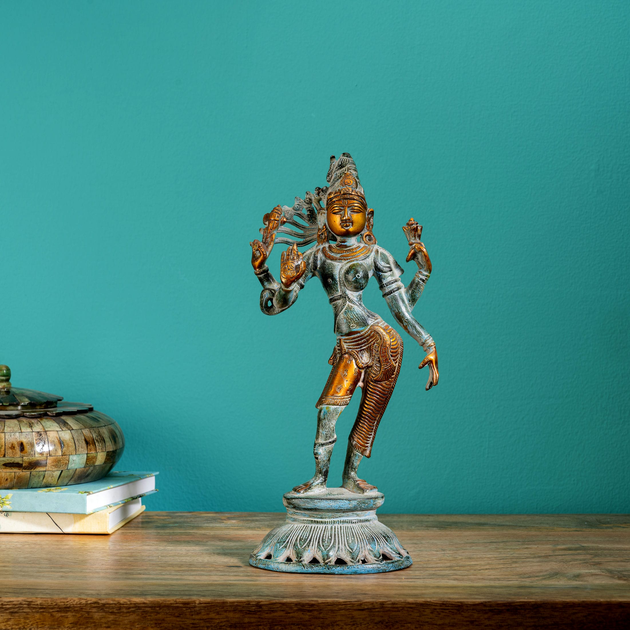 Dual-tone Shiva Shakti metal idol with a polished gold-tone face and teal patina for a foyer console or housewarming gift.
