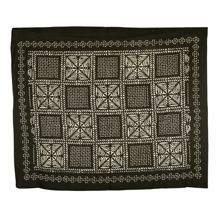 Black appliqué cotton bedcover featuring a geometric cut-out checkerboard design, styled in a contemporary master suite.