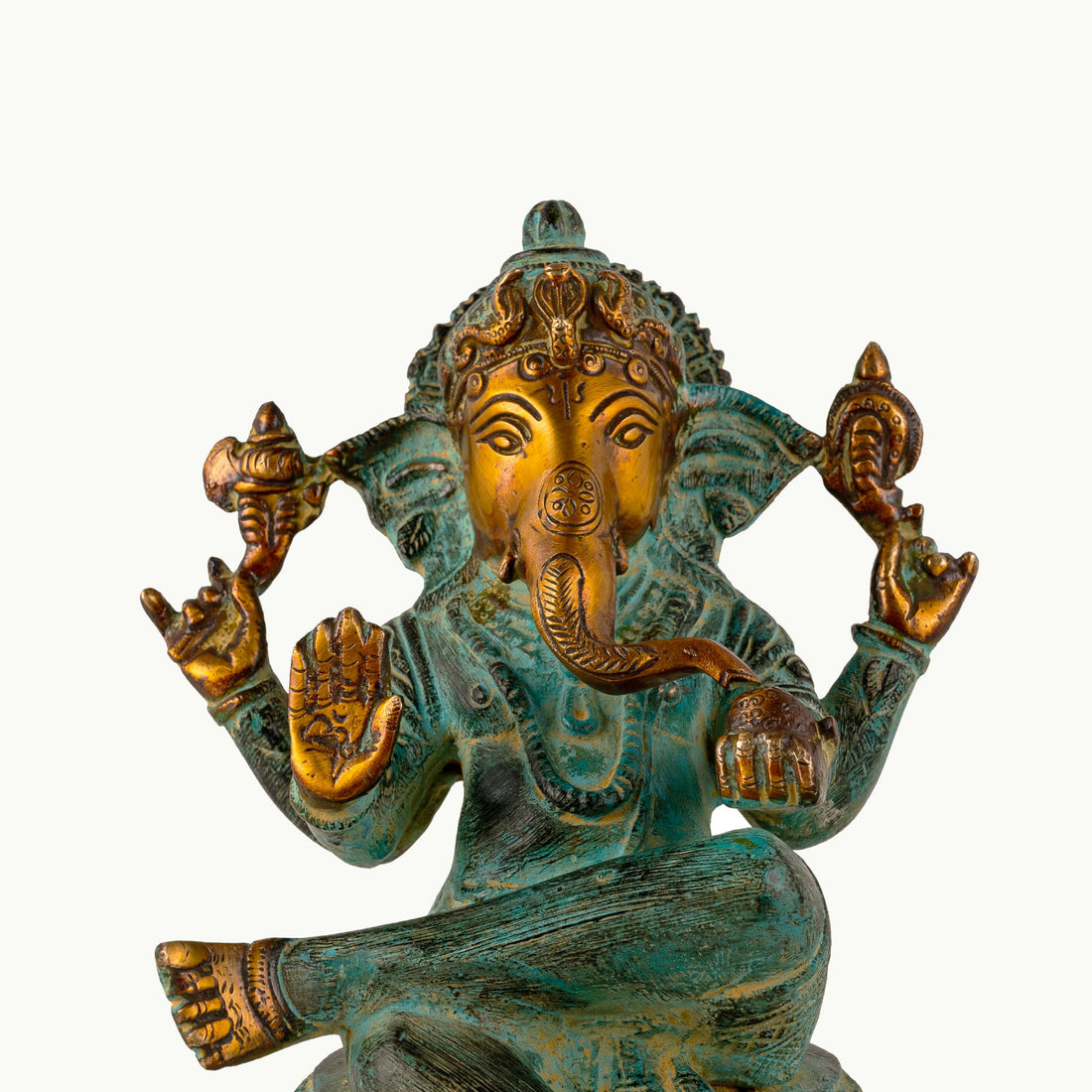 Verdigris Brass Seated Ganesha in a relaxed Lalitasana for a light-wood console.