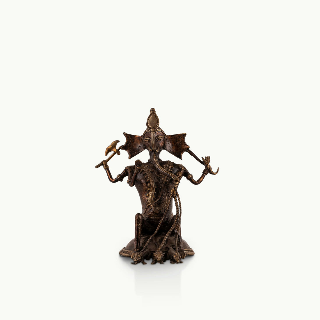 Dhokra Brass Ganesha Statue holding a tribal axe for a light-grained wooden console. 