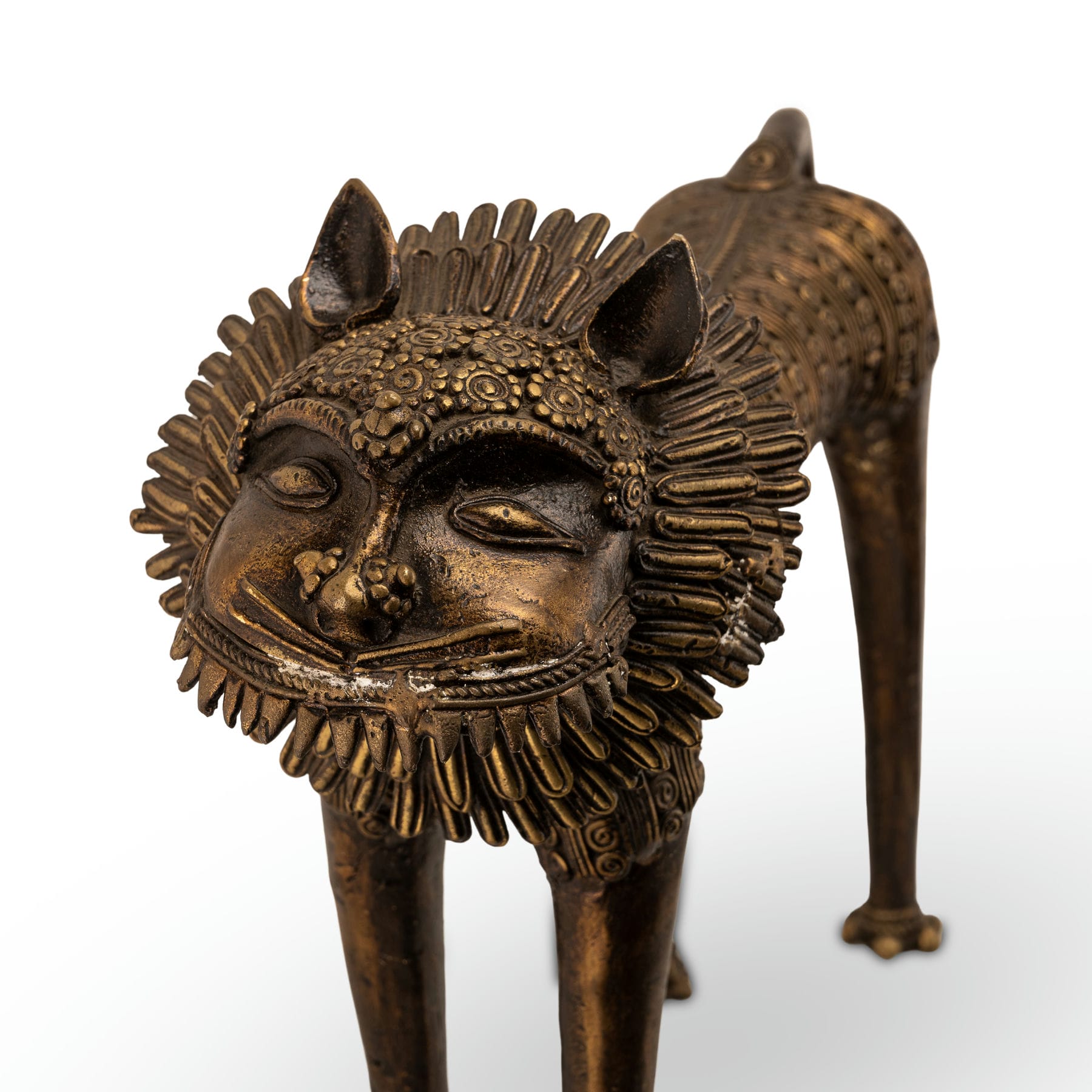 Dhokra style bronze feline featuring a wire-like mane and tribal geometry for a wide mantelpiece or rustic home styling.