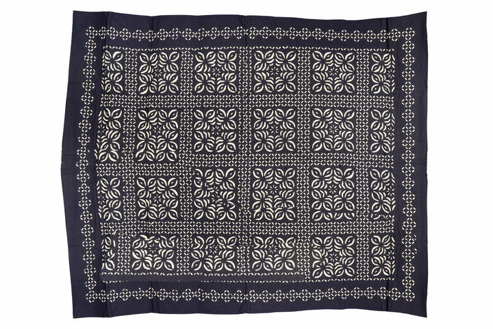 Monochrome kantha cotton bedcover featuring a black and cream geometric mandala. Ideal for contemporary minimalist bedroom styling.