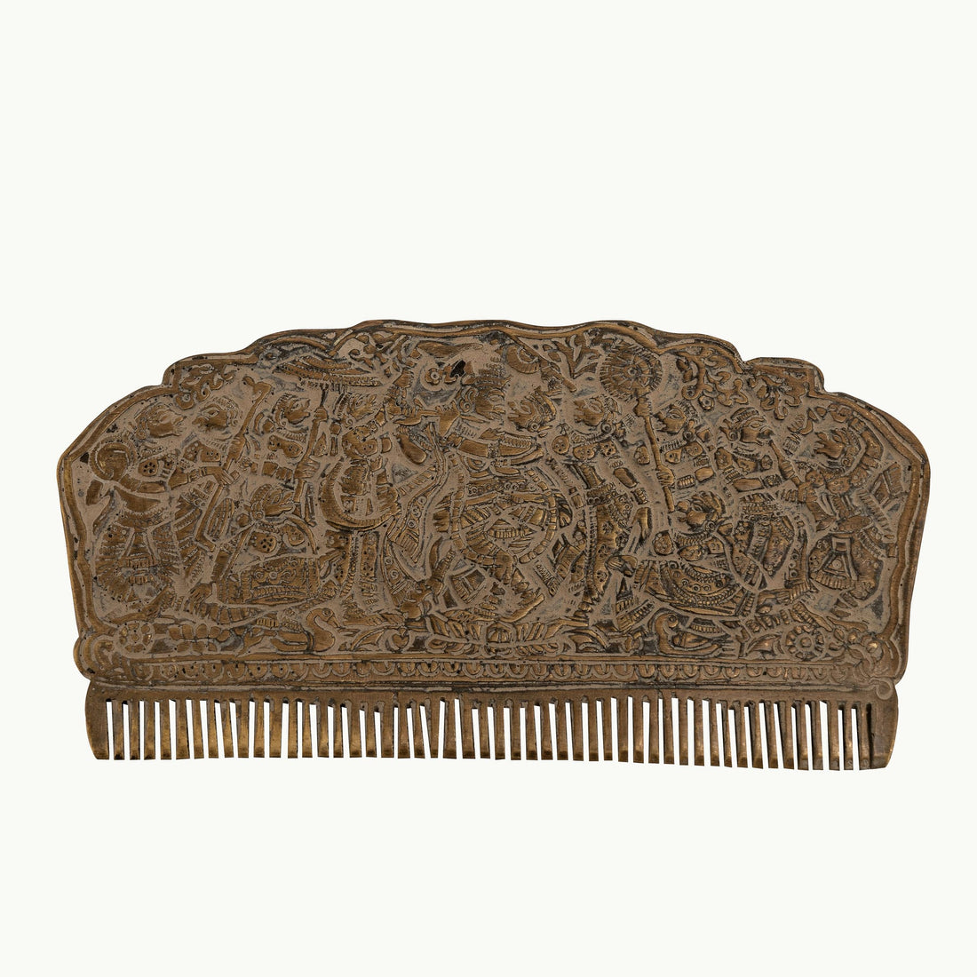 Engraved Brass Decorative Comb displaying a dense narrative tapestry on a mirrored dressing table. 