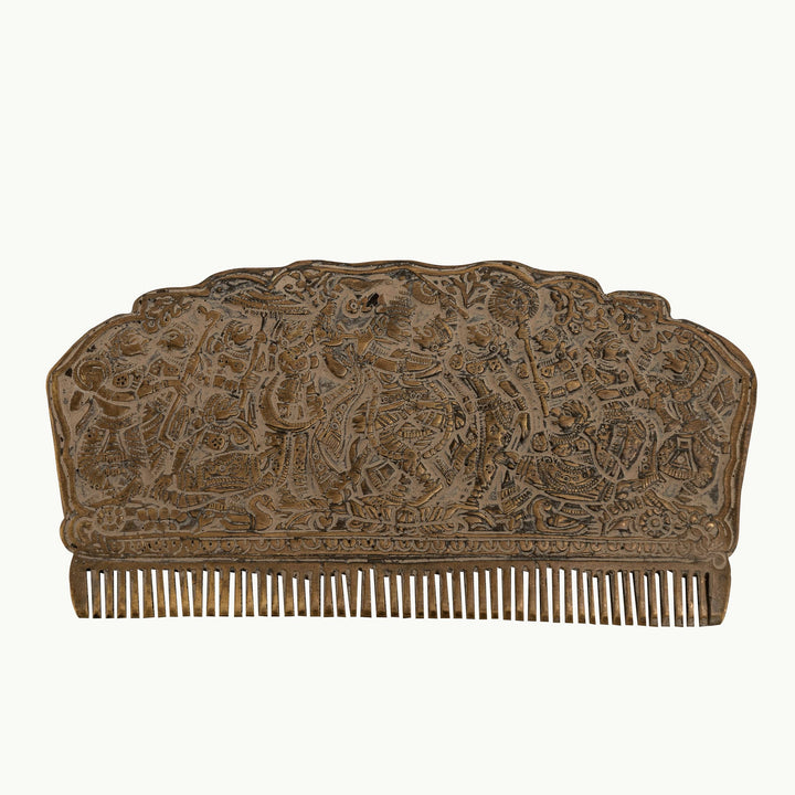 Engraved Brass Decorative Comb displaying a dense narrative tapestry on a mirrored dressing table. 