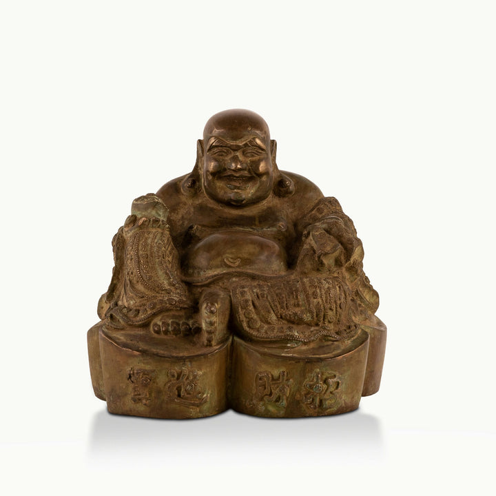 Heavy Brass Laughing Buddha Statue offering joyous abundance in a living room corner. 