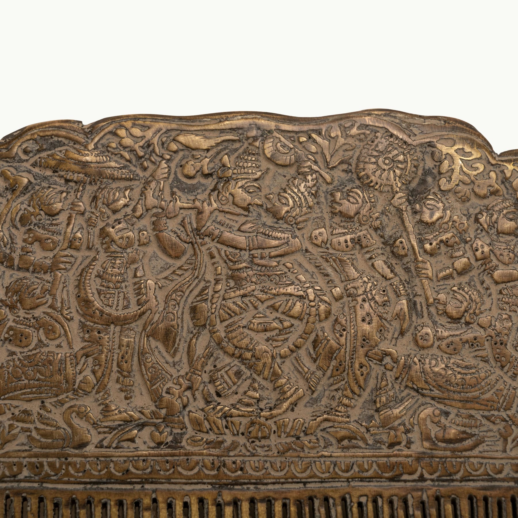 Engraved Brass Decorative Comb displaying a dense narrative tapestry on a mirrored dressing table. 