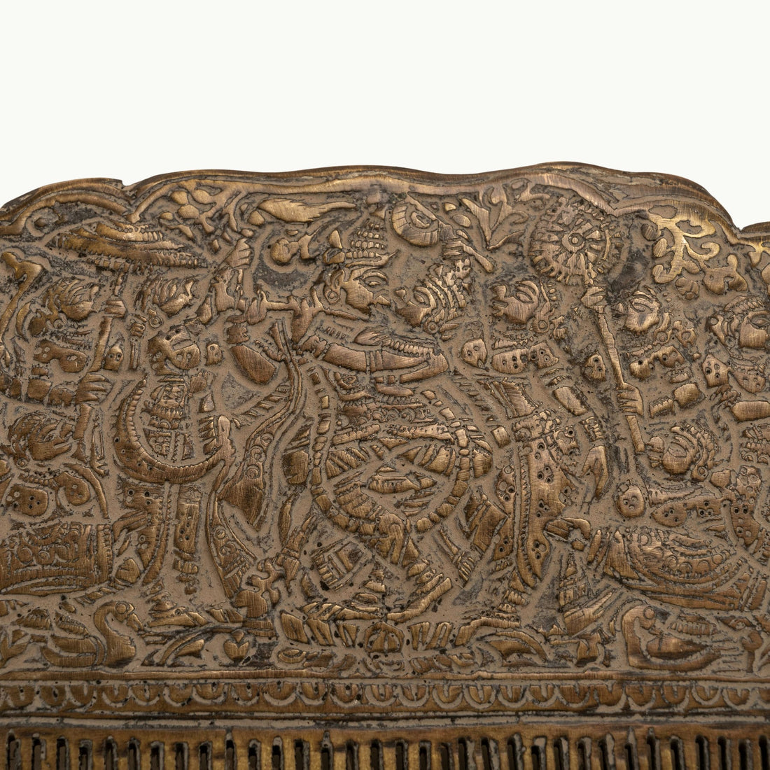 Engraved Brass Decorative Comb displaying a dense narrative tapestry on a mirrored dressing table. 