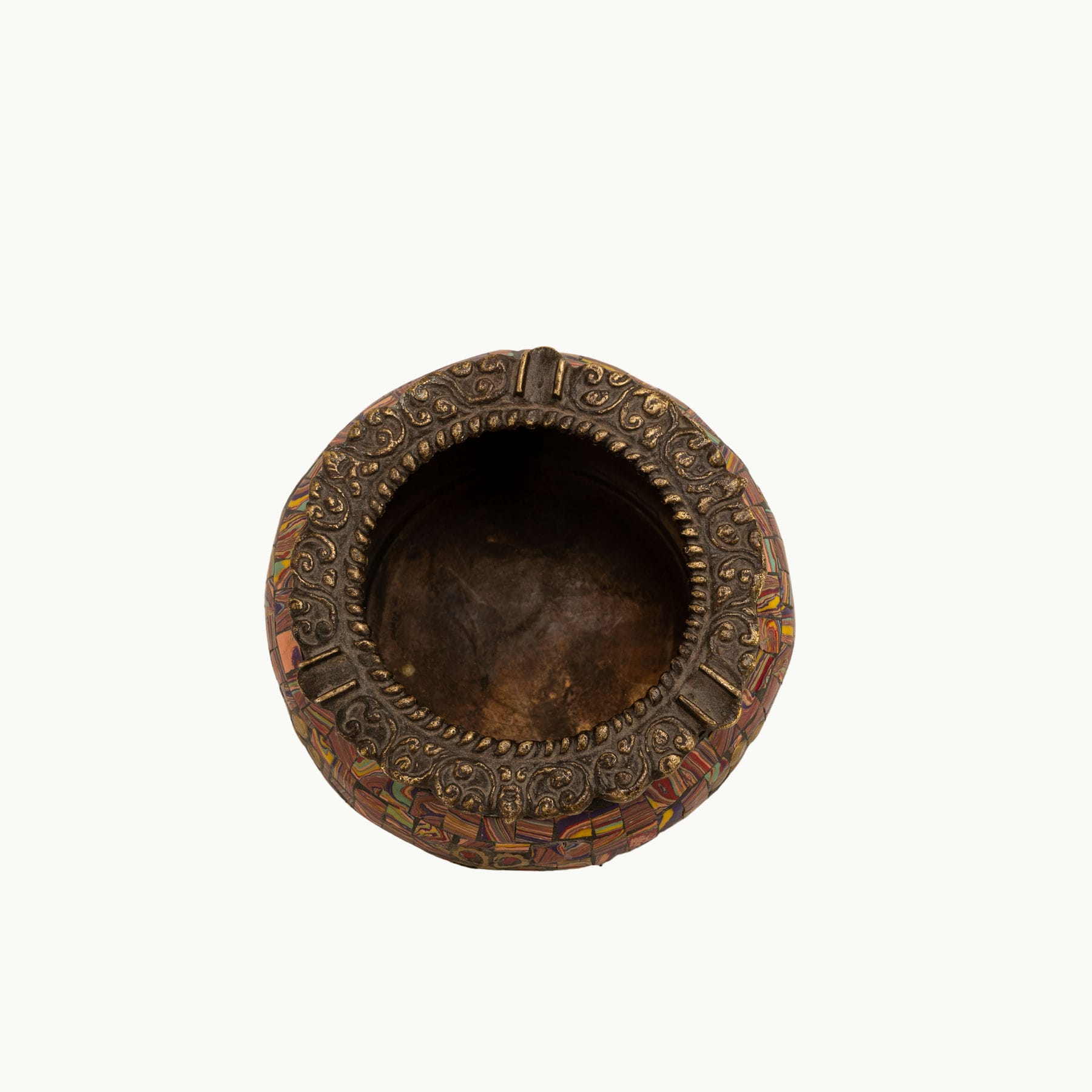 Brass Elephant Foot Mosaic Ashtray decorated with vibrant stones on a dark wood coffee table. 