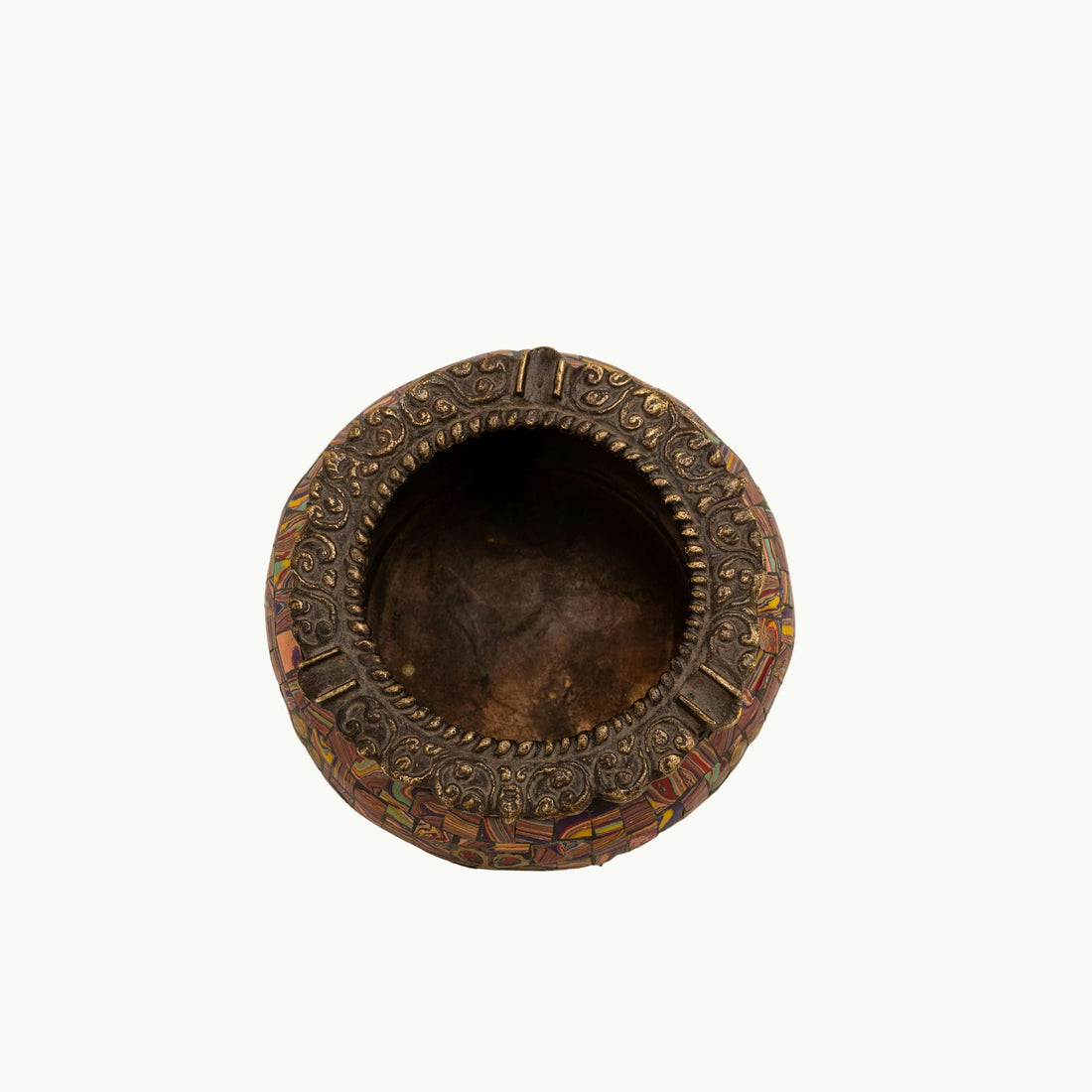 Brass Elephant Foot Mosaic Ashtray decorated with vibrant stones on a dark wood coffee table. 