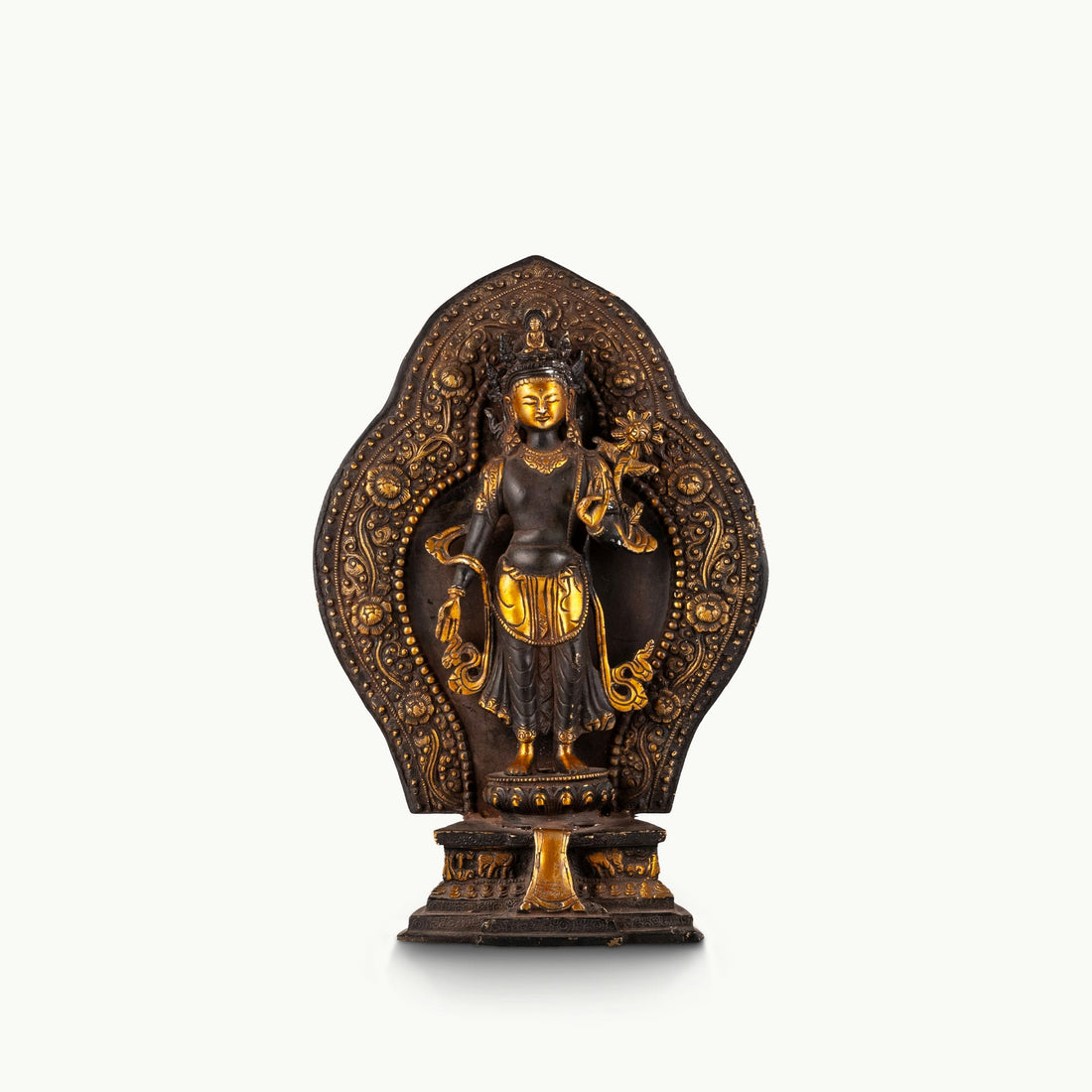 Black Oxidized Standing Tara Statue framed by a golden aureole for a home altar.