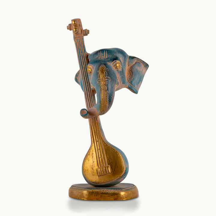 Painted Brass Musical Ganesha Sculpture integrated with a Veena on a minimalist credenza