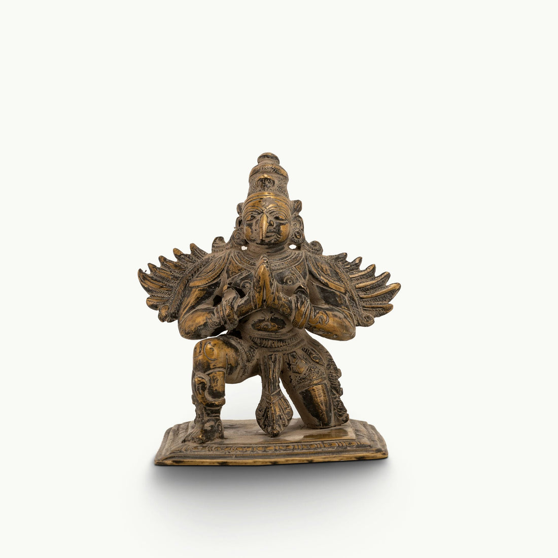 Antique Brass Garuda Statue kneeling in eternal devotion on a home altar. 