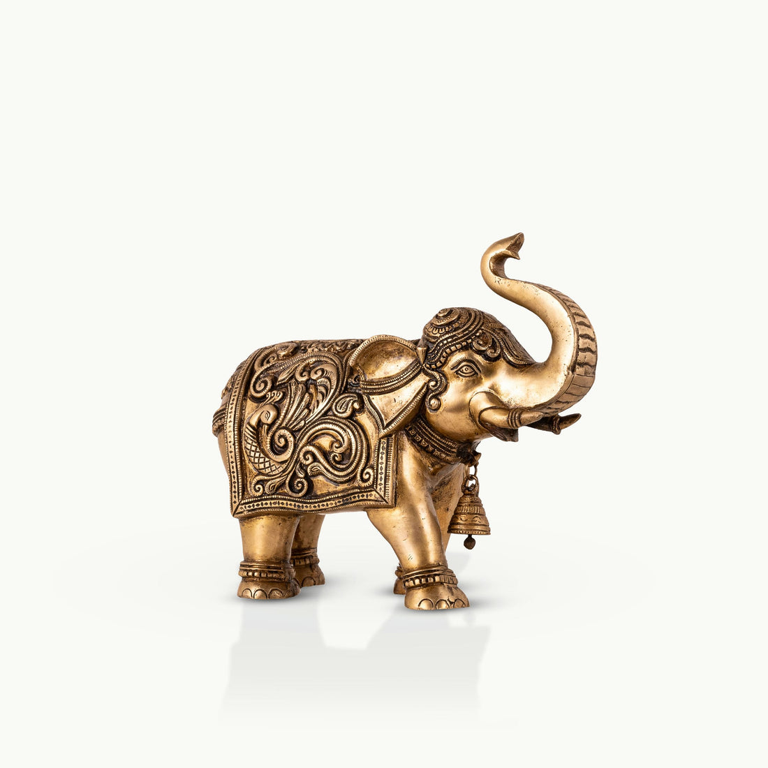 Engraved Golden Brass Elephant with a raised trunk for a dark walnut executive desk.
