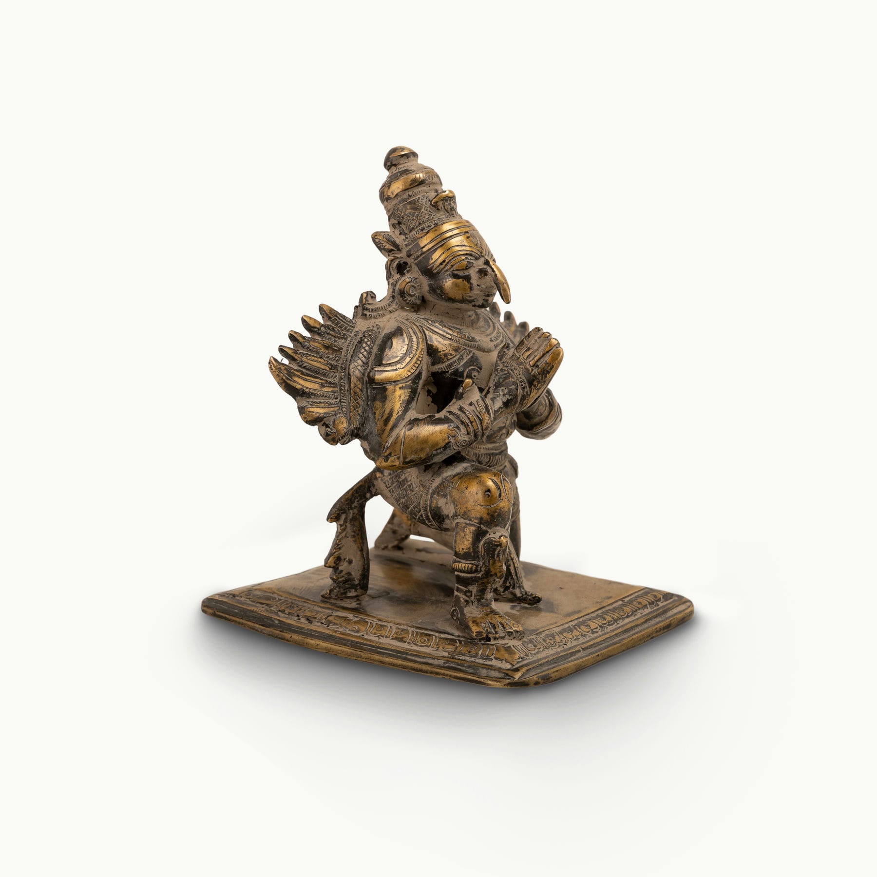 Antique Brass Garuda Statue kneeling in eternal devotion on a home altar. 