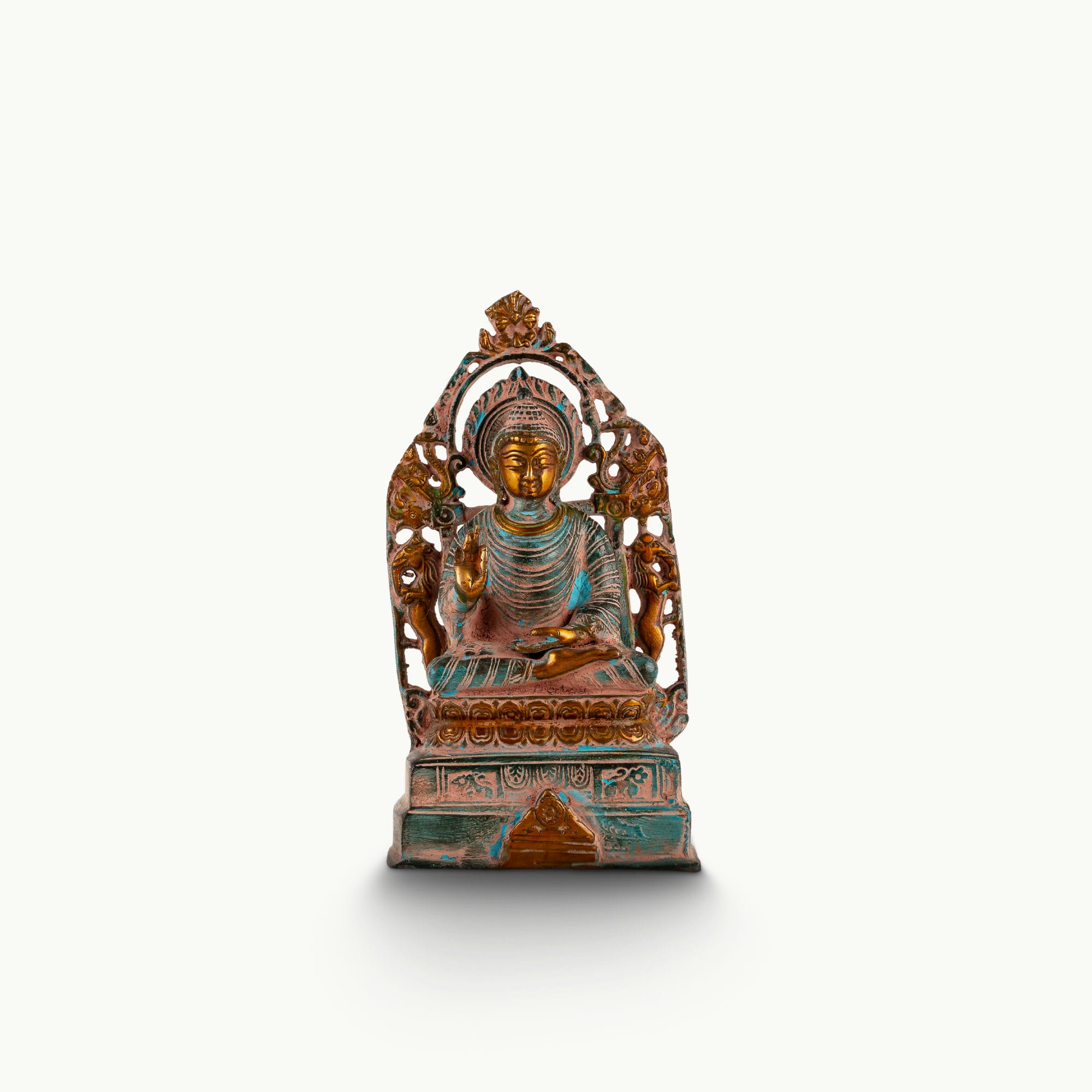 Distressed Brass Buddha Statue with Halo radiating quiet authority on a quiet study bookshelf. 