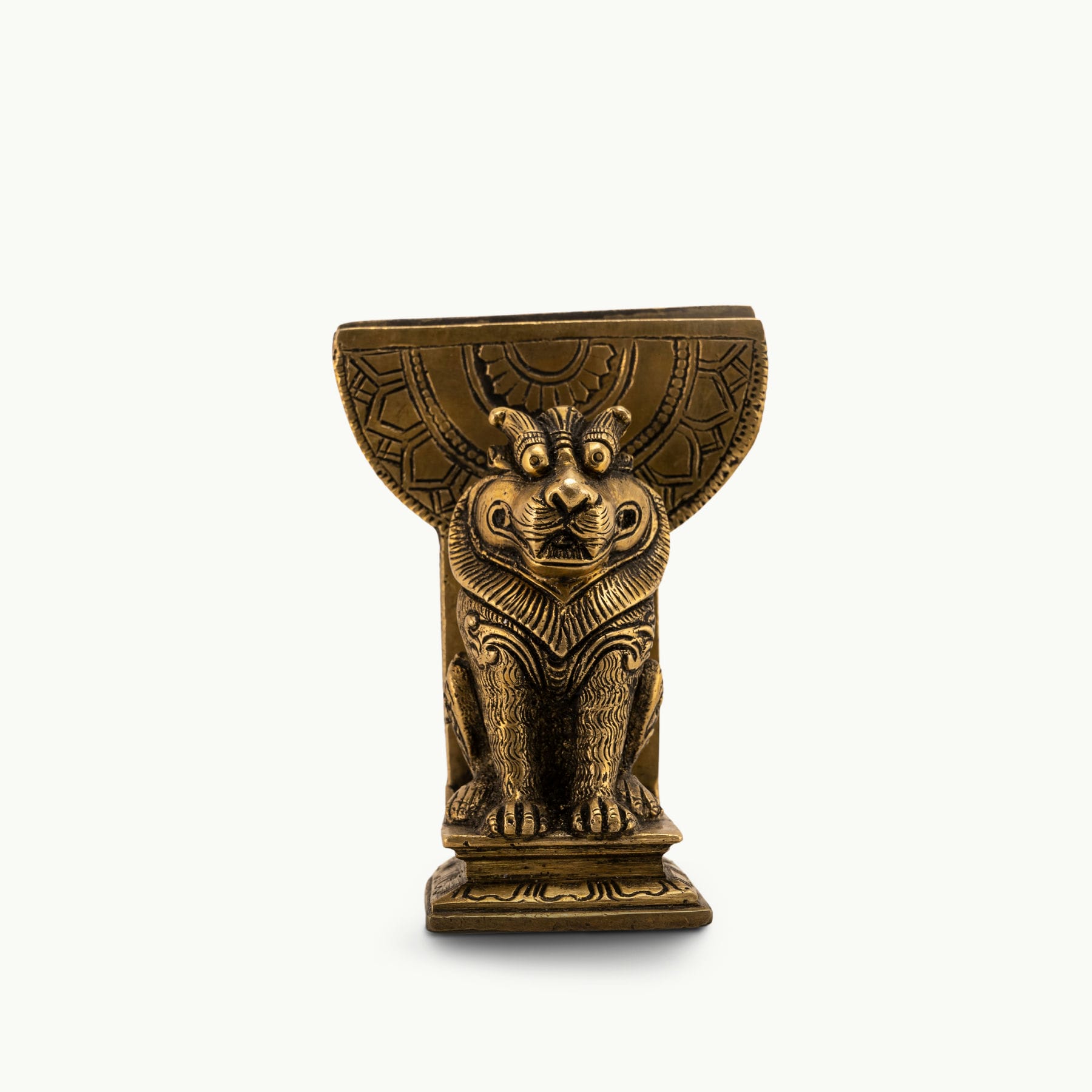 Antique Brass Lion Card Holder standing as a stoic authority on a modern glass console. 