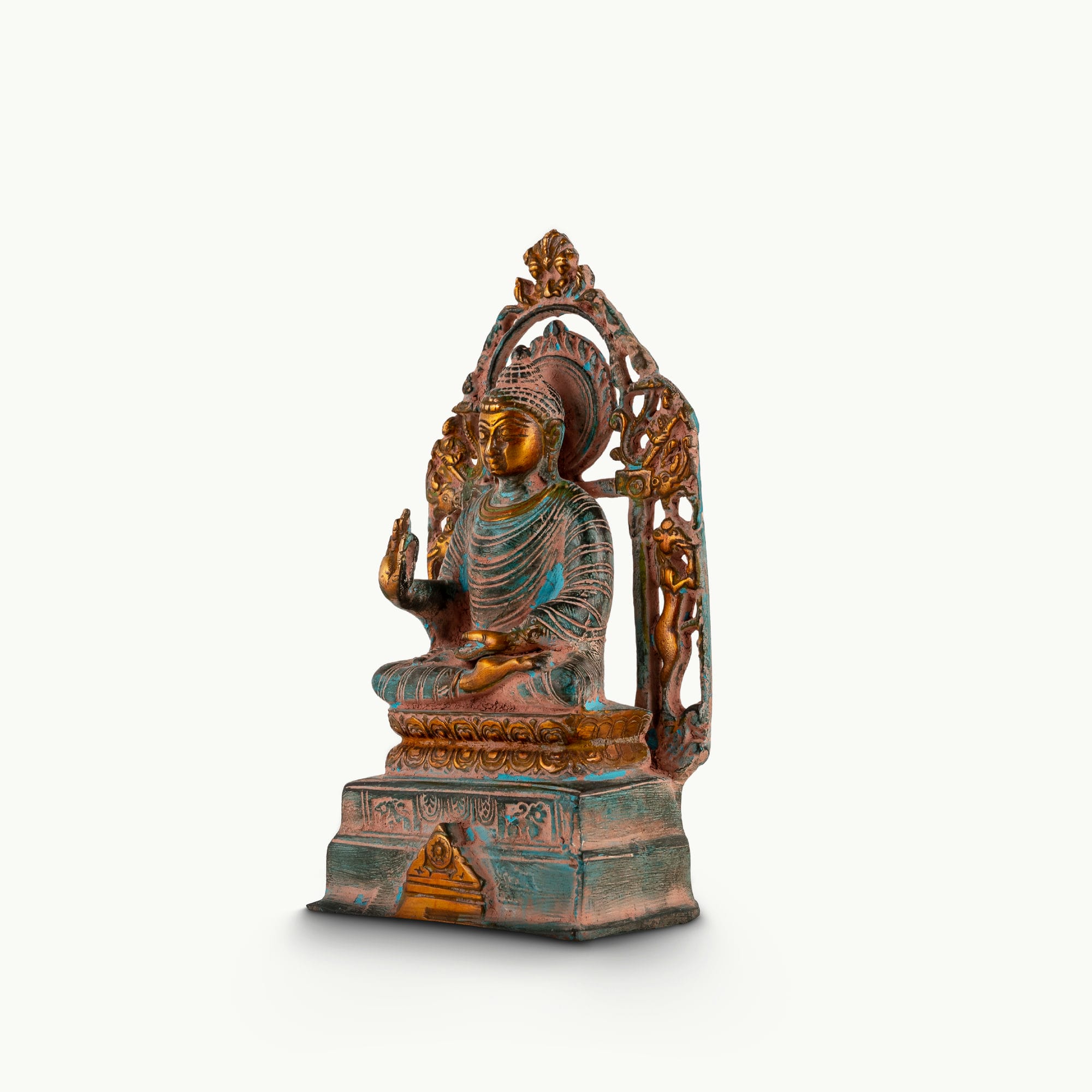 Distressed Brass Buddha Statue with Halo radiating quiet authority on a quiet study bookshelf. 