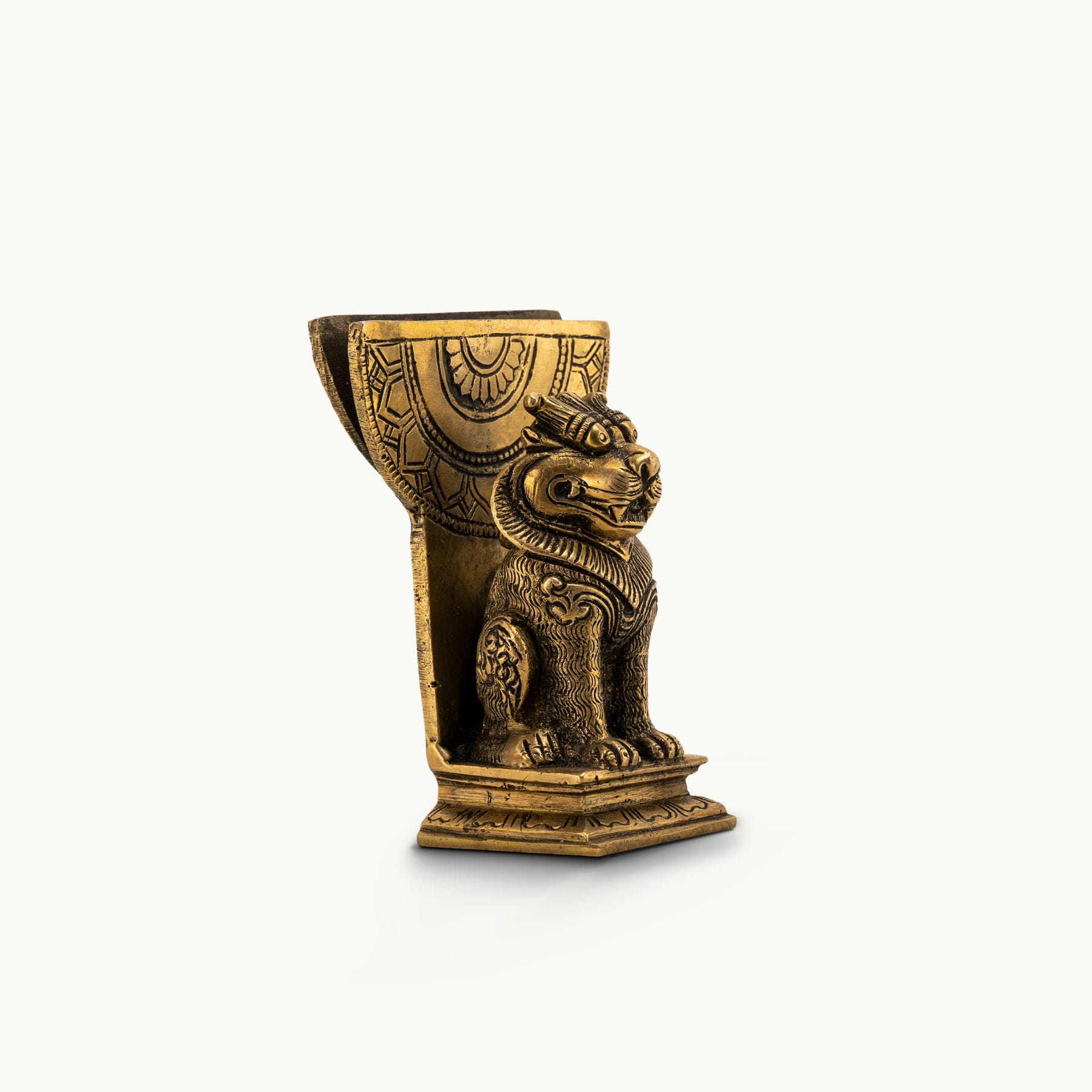 Antique Brass Lion Card Holder standing as a stoic authority on a modern glass console. 