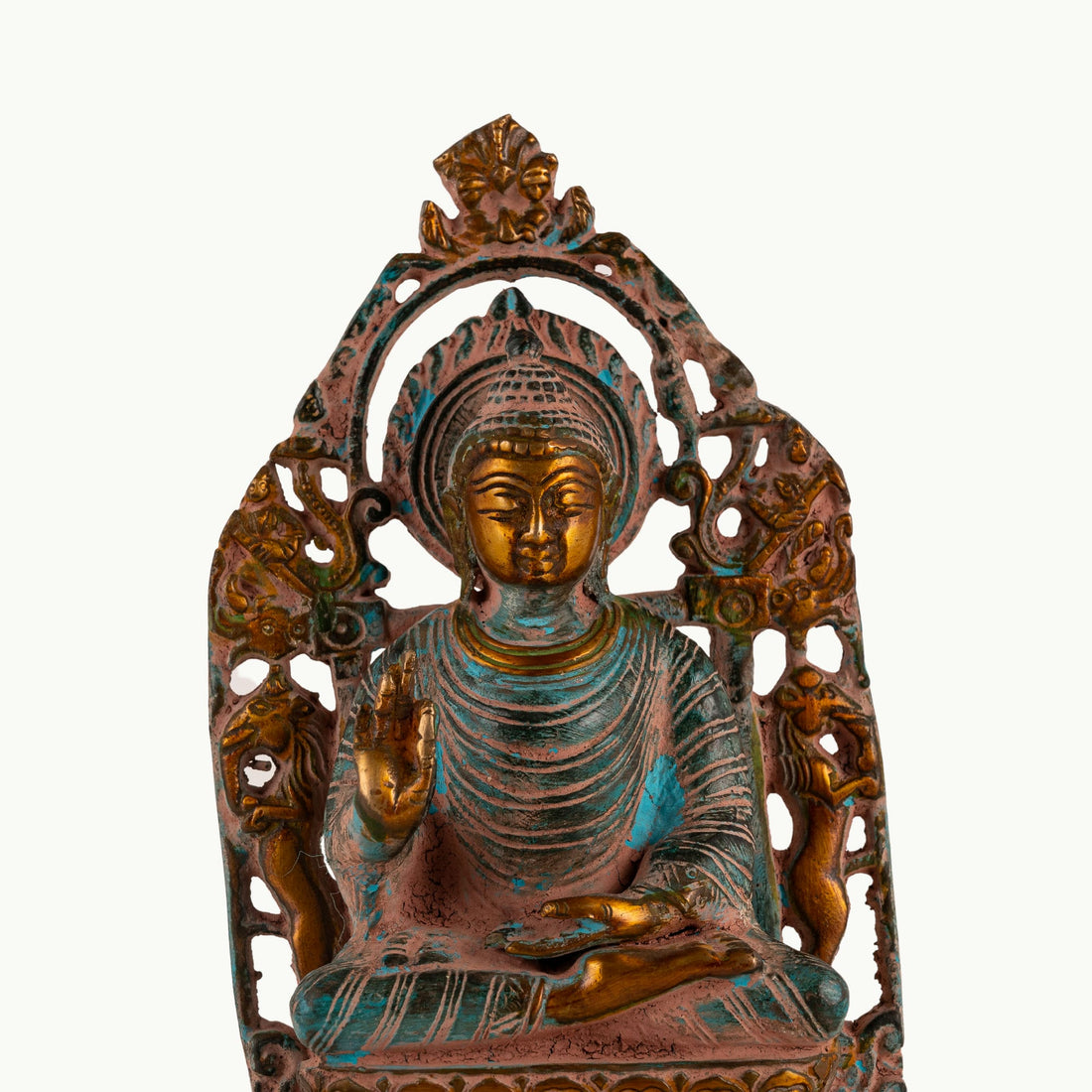Distressed Brass Buddha Statue with Halo radiating quiet authority on a quiet study bookshelf. 