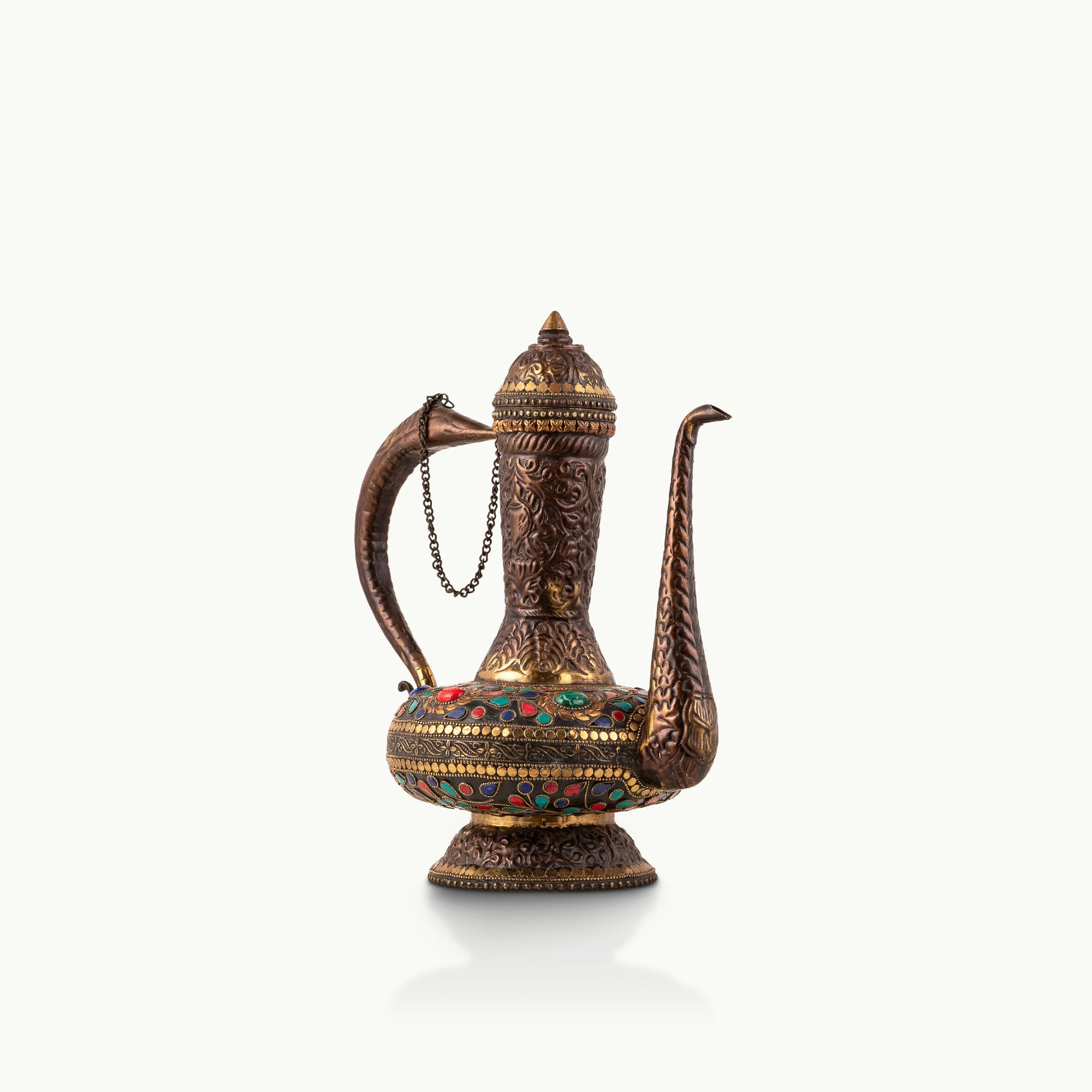 Stone Inlay Antique Brass Ewer featuring a stylized avian handle for a dark walnut sideboard.