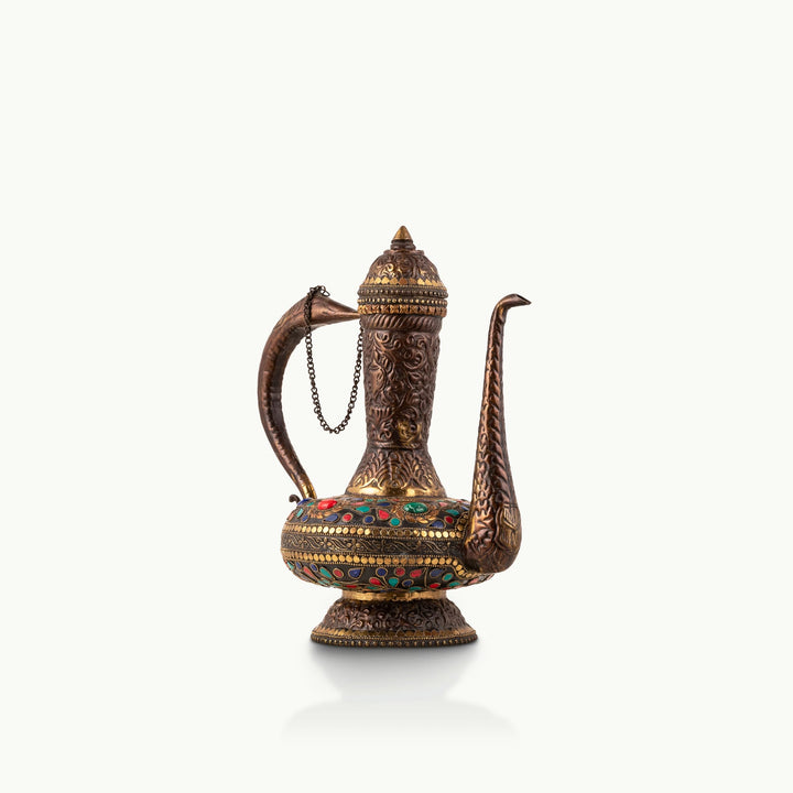 Stone Inlay Antique Brass Ewer featuring a stylized avian handle for a dark walnut sideboard.