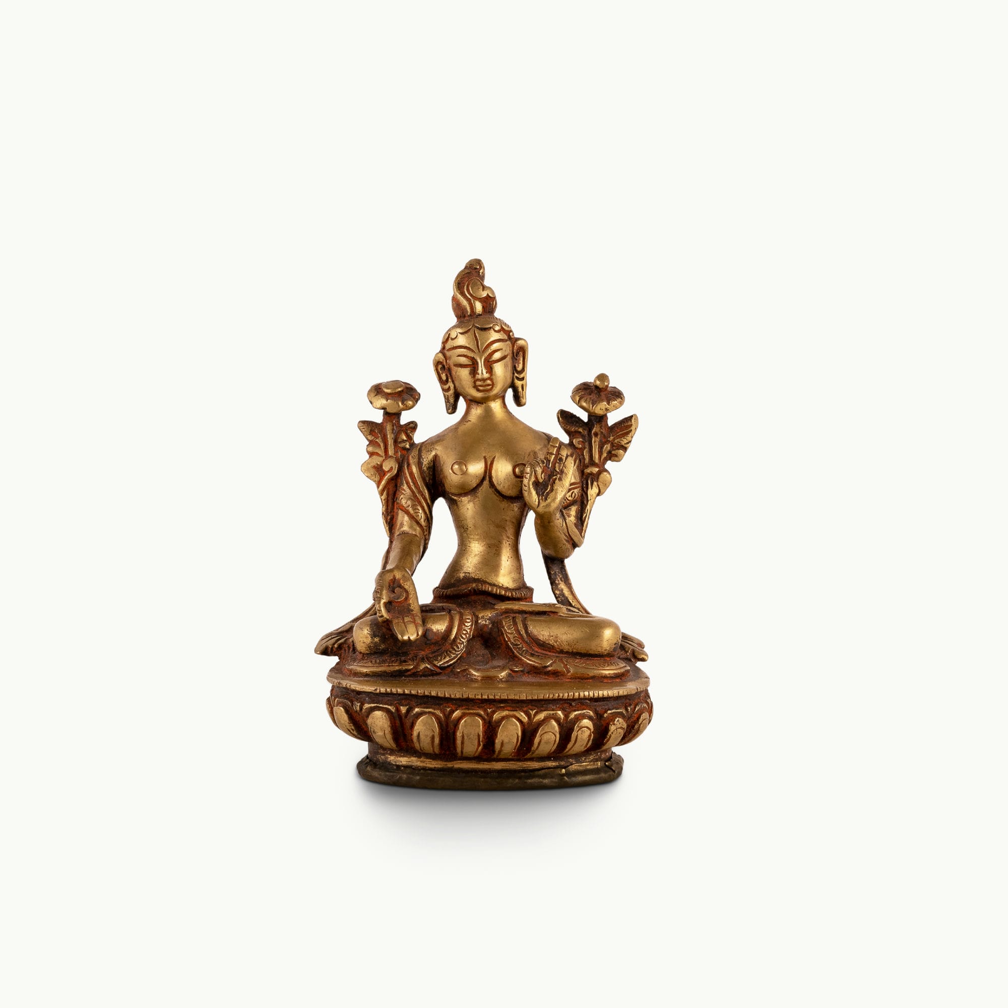 Polished Brass Tara Statue emerging from stylized lotus petals on a bedside table. 