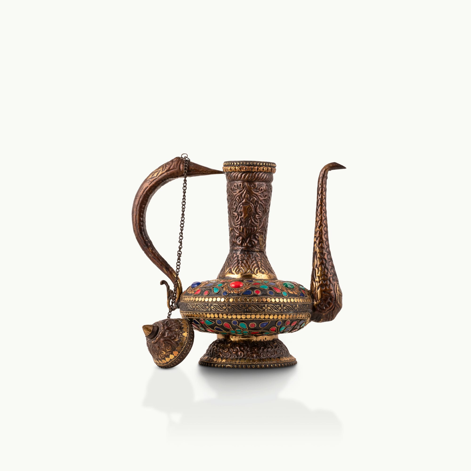 Stone Inlay Antique Brass Ewer featuring a stylized avian handle for a dark walnut sideboard.