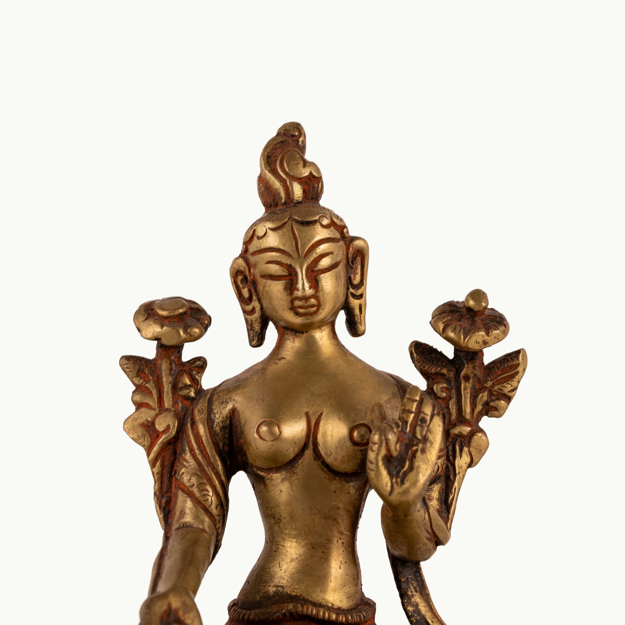 Polished Brass Tara Statue emerging from stylized lotus petals on a bedside table. 