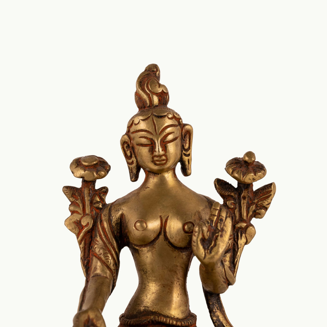 Polished Brass Tara Statue emerging from stylized lotus petals on a bedside table. 