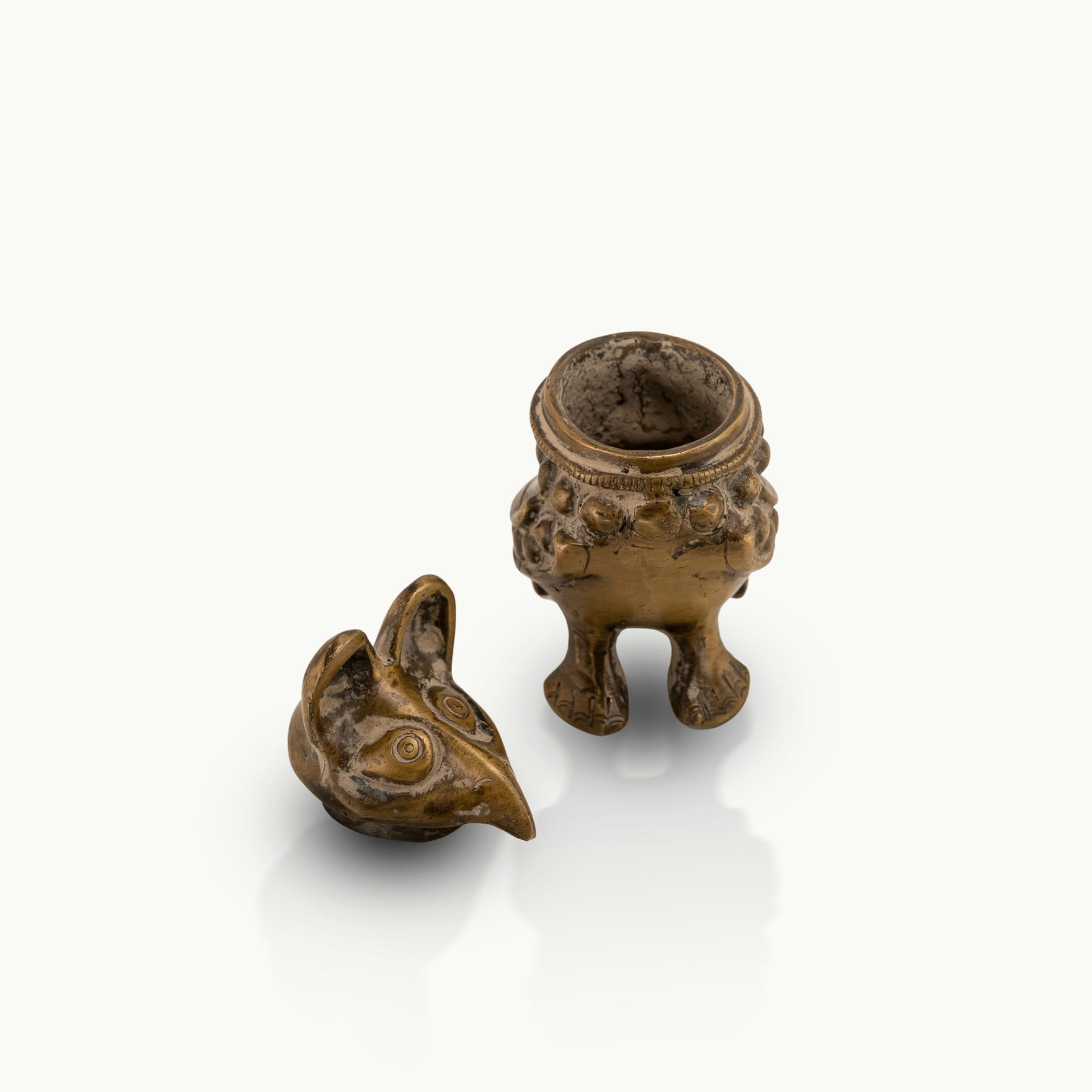 Antique Brass Bird Boxes concealing small inner chambers on a mirrored dressing table. 