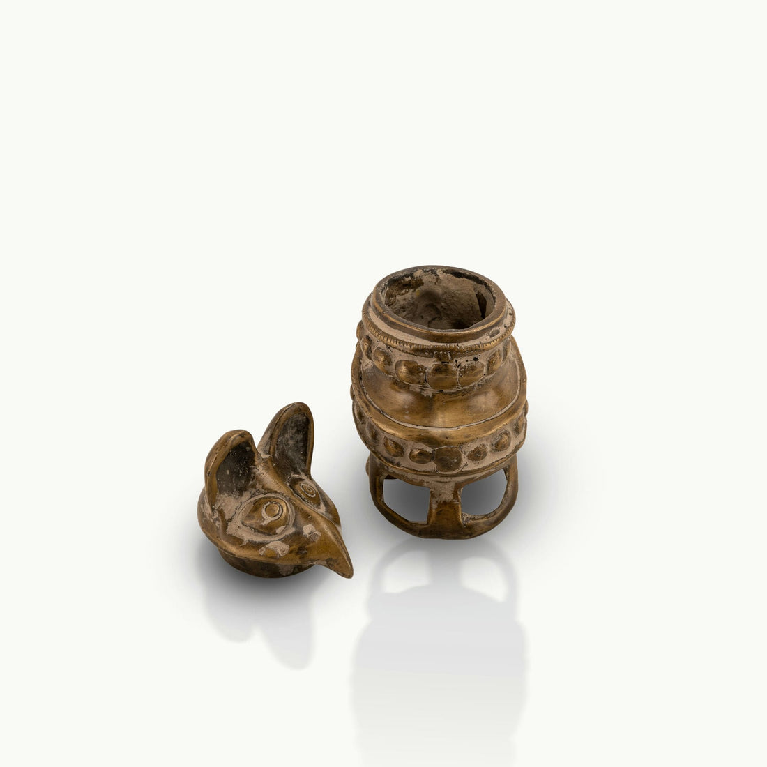 Antique Brass Bird Boxes concealing small inner chambers on a mirrored dressing table. 