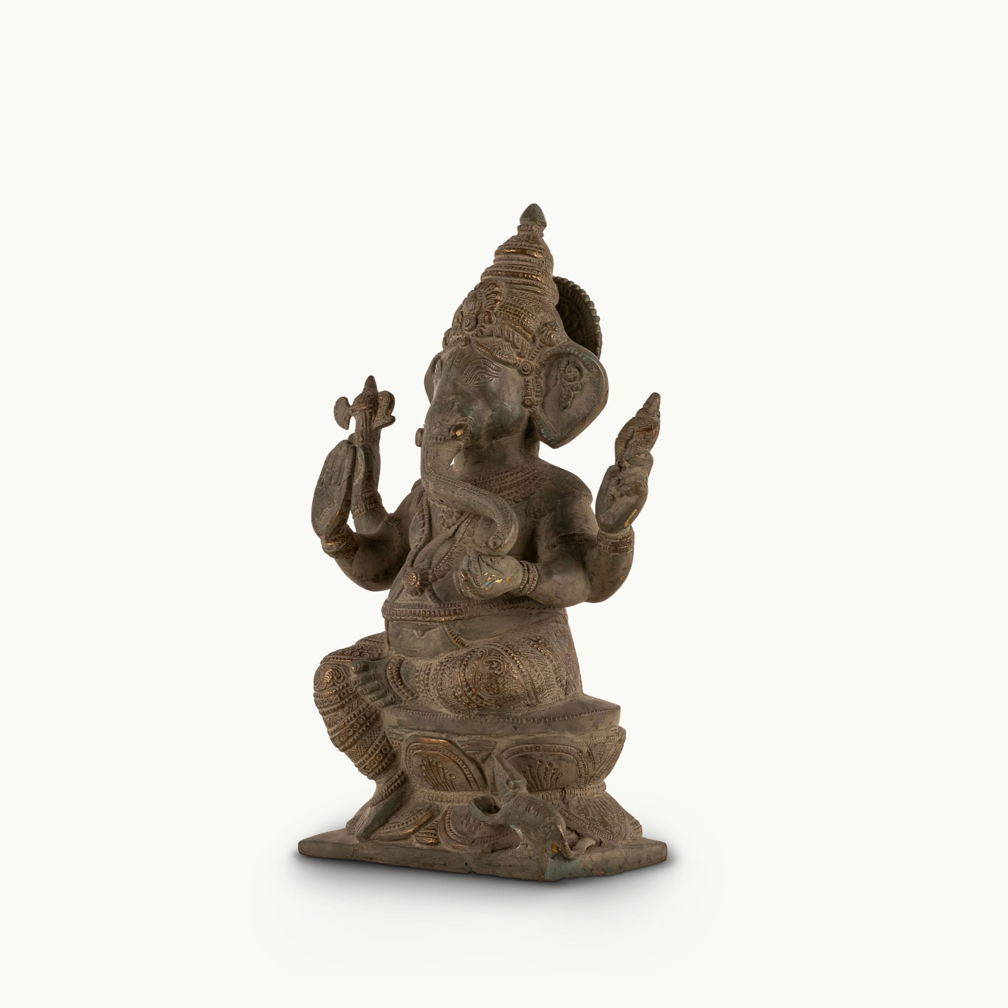 Distressed Brass Ganesha Statue sitting in a regal posture on an east-facing home altar. 